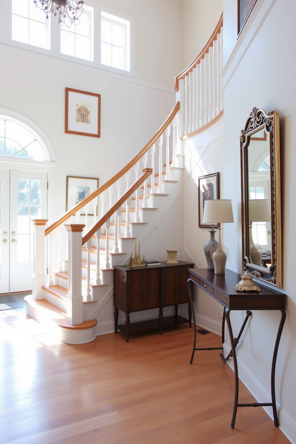 A bright and airy foyer features a stunning white staircase with a polished wooden handrail that adds warmth to the space. The walls are adorned with elegant artwork, and a stylish console table sits against one side, topped with decorative accents and a chic mirror above. The flooring is a light-colored hardwood that complements the staircase beautifully. Natural light floods the area through large windows, highlighting the inviting atmosphere and creating a perfect entryway to the home.