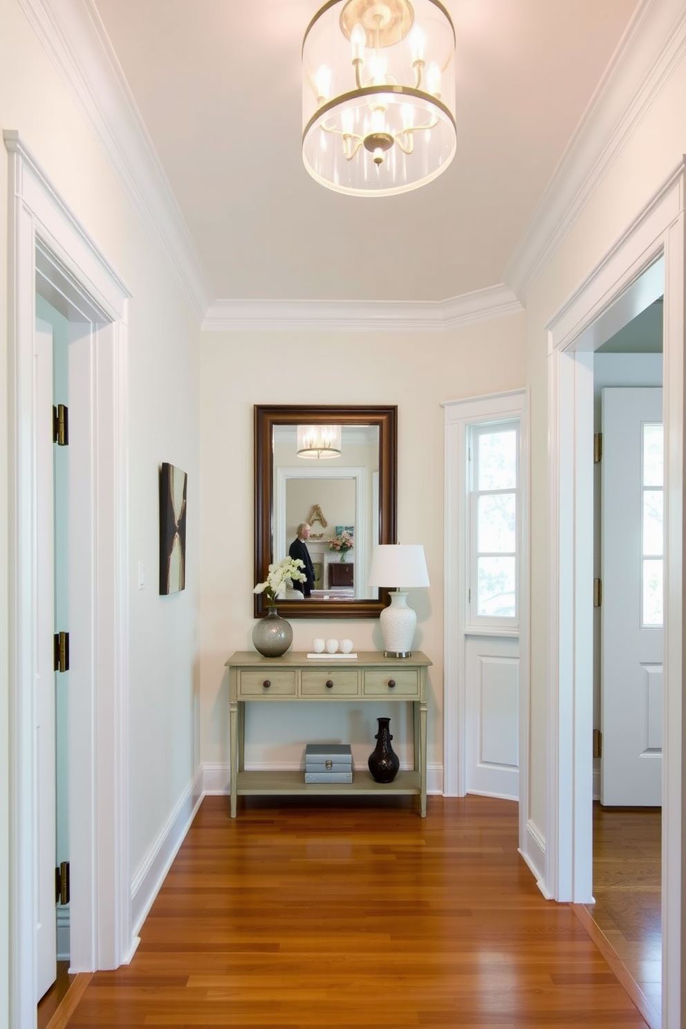 A bright and airy foyer features crisp white trim around the doorways and windows, creating a clean and inviting atmosphere. The walls are painted in a soft pastel hue, complementing the elegant light fixture hanging from the ceiling. A stylish console table is positioned against one wall, adorned with decorative items and a large mirror above it. The floor is finished with polished hardwood, enhancing the overall warmth of the space.