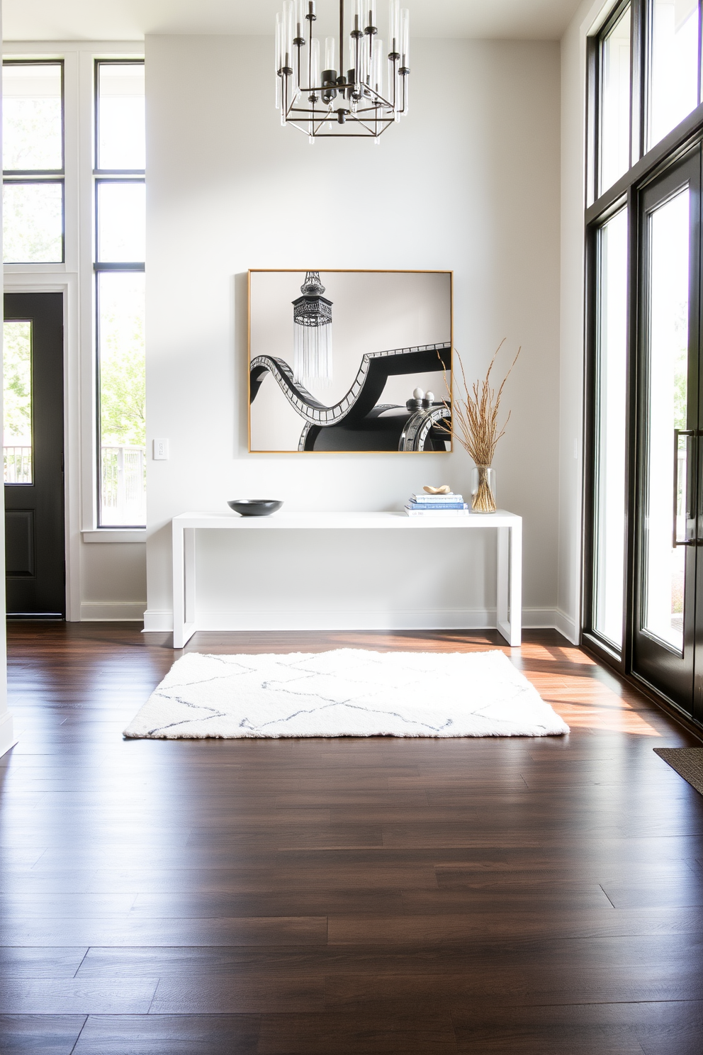 A stylish white rug is placed under a sleek console table in a bright foyer. The walls are adorned with elegant artwork, and natural light floods the space through large windows, creating an inviting atmosphere.