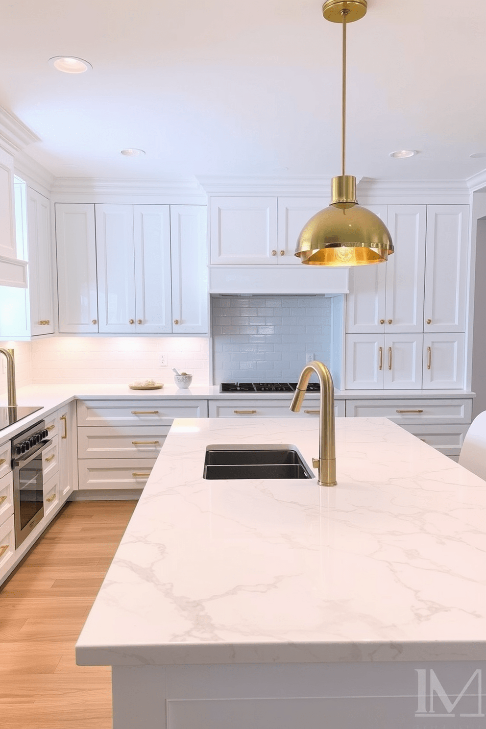 A sleek white kitchen features cabinetry with clean lines and gold fixtures that add a touch of elegance. The countertops are made of polished quartz, complementing the bright and airy atmosphere of the space. The kitchen island is topped with a stunning marble surface, providing ample space for meal preparation and casual dining. Pendant lights with gold accents hang above the island, creating a warm and inviting focal point in the room.