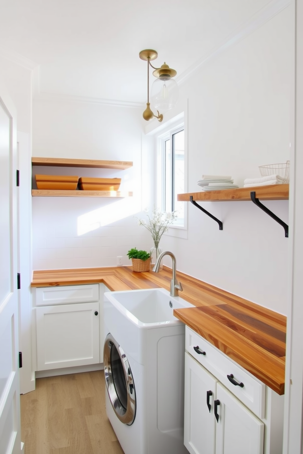 A bright and airy laundry room featuring a combination of white cabinetry and natural wood finishes. The space includes a large farmhouse sink with a wooden countertop, complemented by open shelving made of reclaimed wood. The walls are painted in a crisp white, creating a clean backdrop for the warm tones of the wood. Elegant pendant lighting hangs above, adding a touch of sophistication to the functional layout.