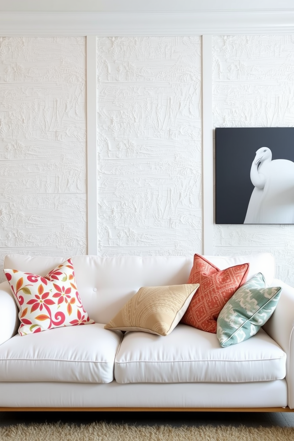 Textured wall panels add depth and character to a white living room. The space features a plush white sofa adorned with colorful accent pillows, creating a cozy yet sophisticated atmosphere.