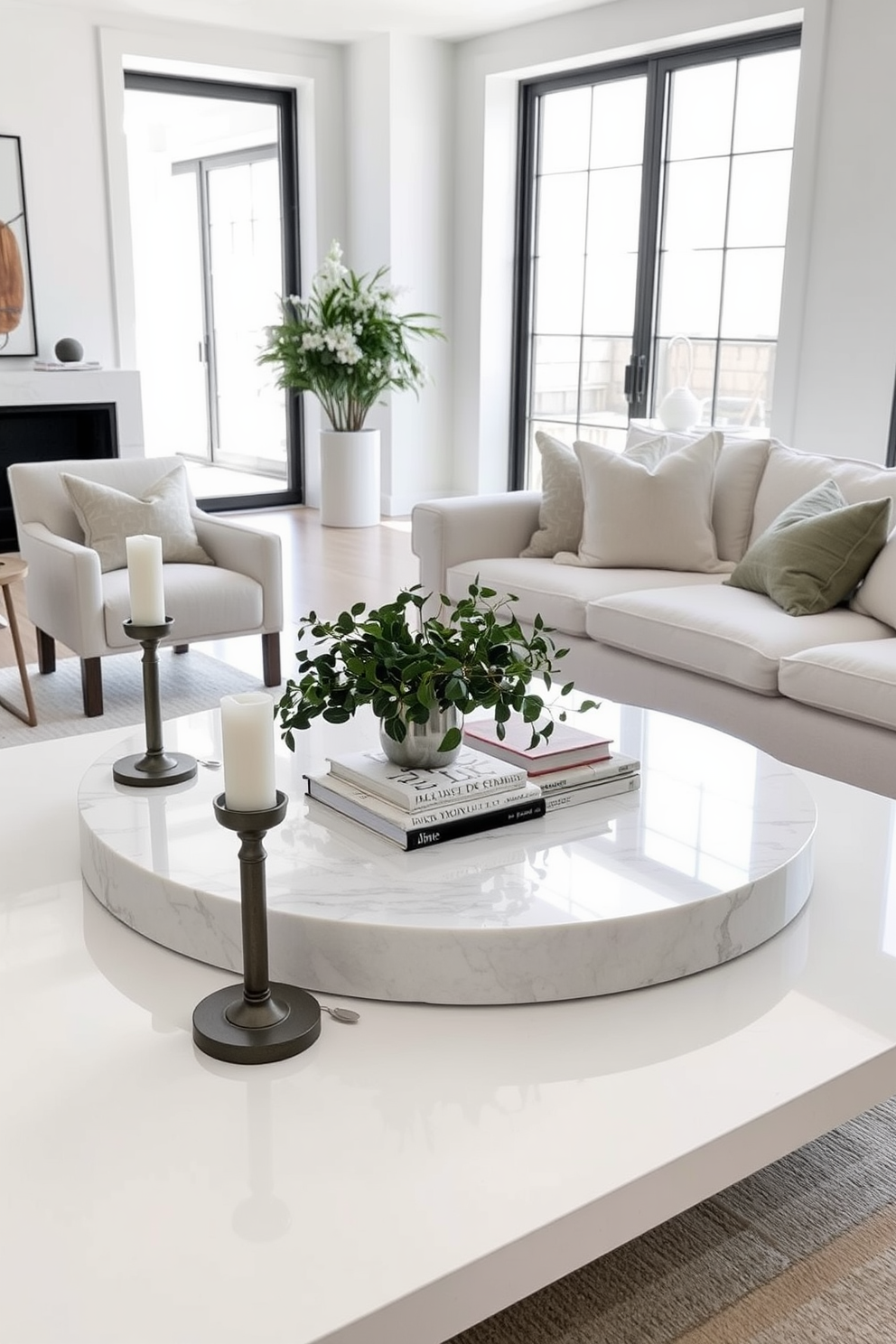 A chic white coffee table centerpiece features a large, round marble tray at its center, adorned with a stylish arrangement of fresh greenery and a few art books. Surrounding the tray are elegant candle holders in varying heights, adding a touch of warmth and sophistication to the space. The white living room design showcases a plush, oversized sectional sofa dressed in soft, textured fabrics, complemented by a pair of sleek accent chairs. Natural light floods the room through large windows, highlighting the minimalist decor and a neutral color palette that creates a serene atmosphere.