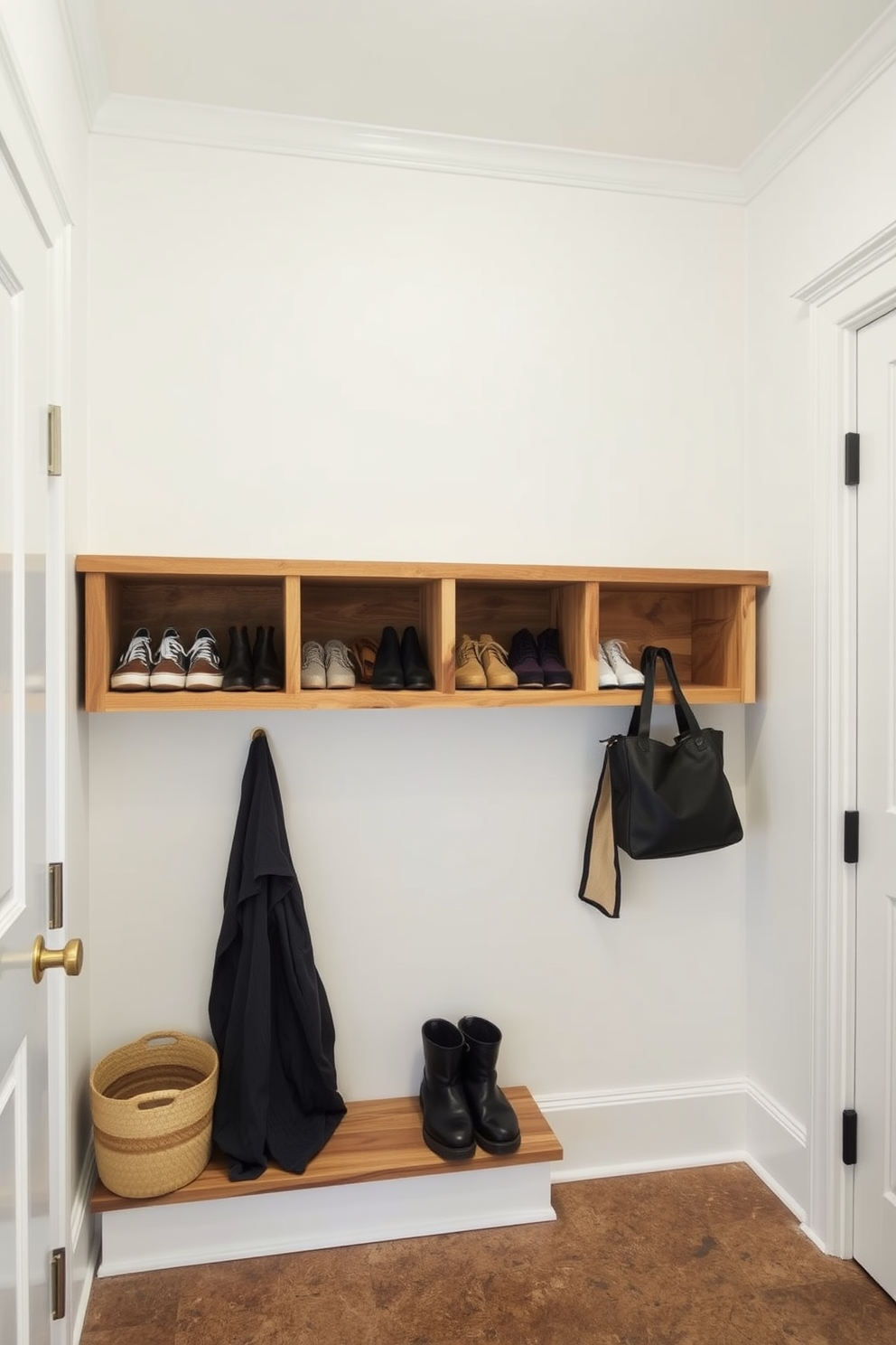 A bright and airy mudroom features open shelving made of reclaimed wood, showcasing neatly arranged shoes and accessories. The walls are painted in a soft white hue, complemented by a durable, textured floor that adds warmth to the space.