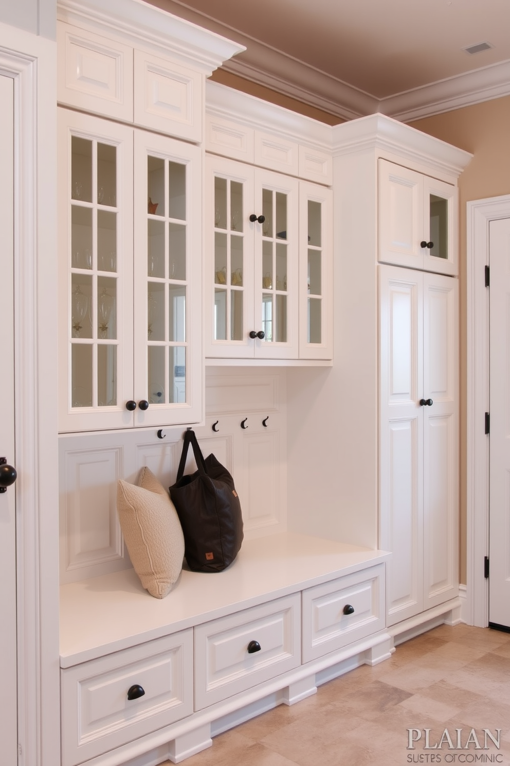 Classic white cabinetry with glass doors creates an elegant and timeless look in a mudroom. The cabinetry features intricate molding and soft-close hinges, providing both functionality and style. The mudroom is designed with a spacious layout that includes a built-in bench with plush cushions. Hooks for coats and bags are installed above, while a durable tile floor ensures easy maintenance and a clean aesthetic.