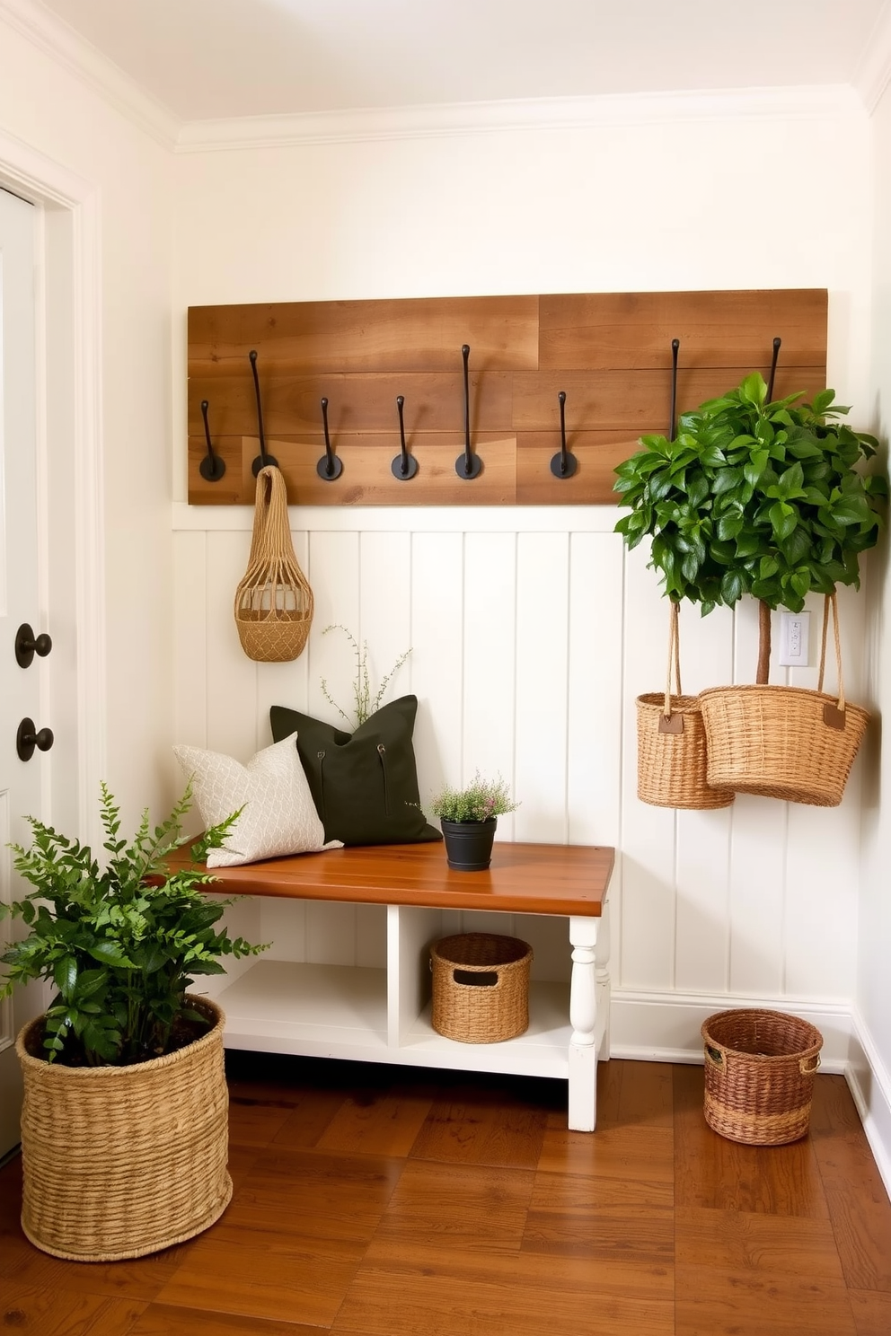 A charming mudroom with vintage hooks mounted on reclaimed wood for a rustic touch. The walls are painted in a soft cream color, and the floor features a distressed hardwood finish. A built-in bench with storage underneath provides a functional seating area. Potted plants and woven baskets add warmth and texture to the space.