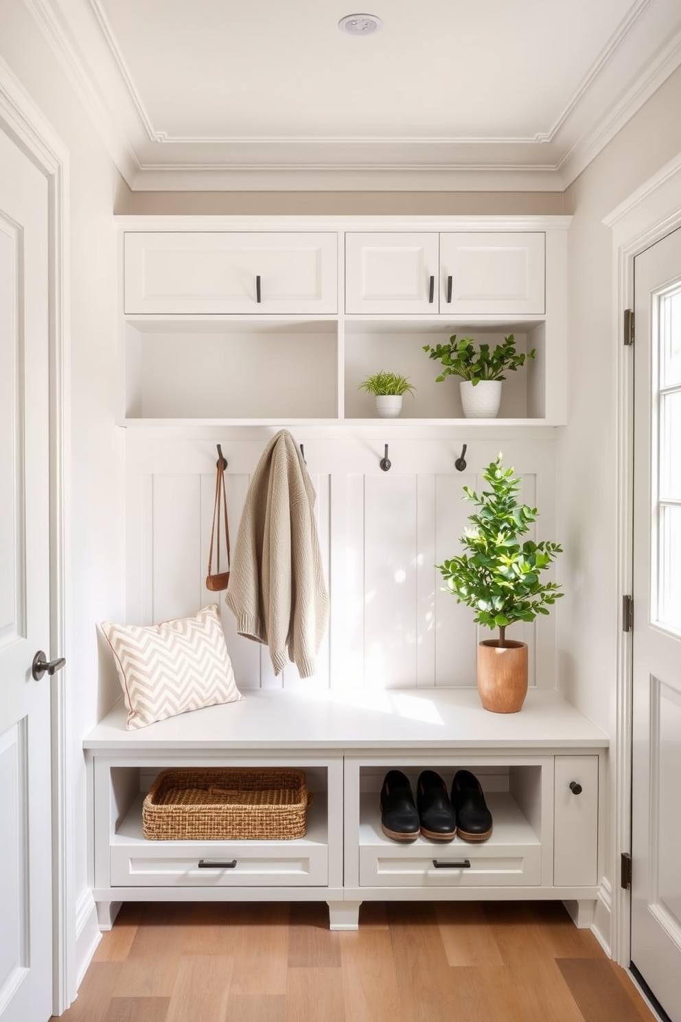 A serene mudroom design featuring a neutral color palette that incorporates soft whites and warm beiges. The space includes built-in cabinetry for storage, with a bench for seating and hooks for hanging coats, creating an inviting and functional entryway. Pops of greenery are added through potted plants placed on the shelves and a small indoor tree in the corner. Natural light floods the room through a nearby window, enhancing the fresh and airy atmosphere of this stylish mudroom.