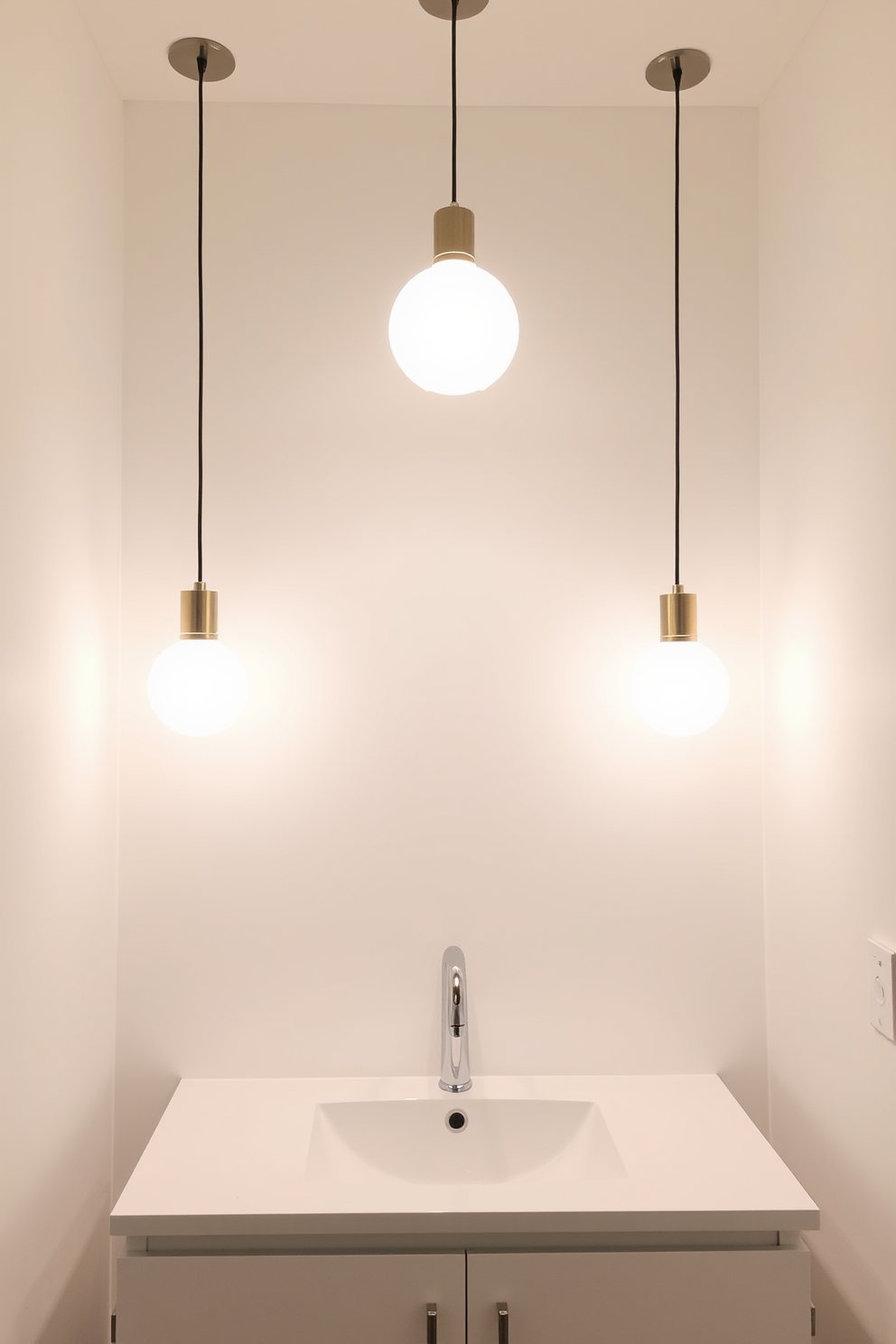 Bright pendant lights hang gracefully above the sink area, casting a warm glow across the space. The walls are painted in a soft white hue, creating an airy and inviting atmosphere. The sink features a sleek, modern design with a polished chrome faucet. A minimalist vanity with clean lines complements the overall aesthetic, providing both style and functionality.