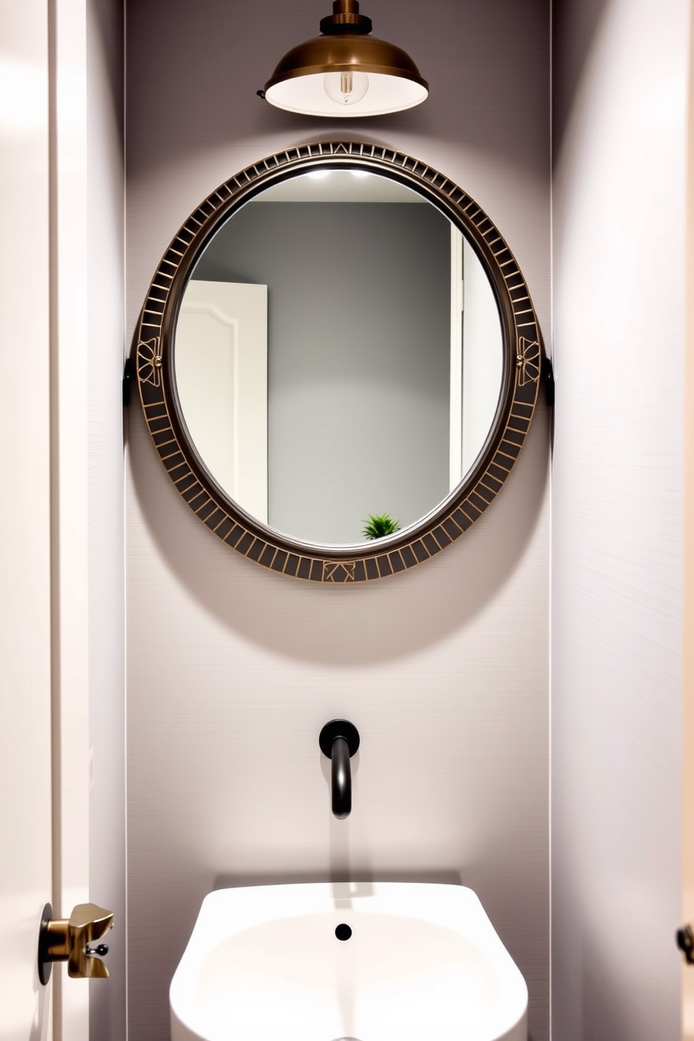 A stylish round mirror with a decorative frame hangs above a sleek white pedestal sink in a chic powder room. The walls are adorned with soft gray wallpaper, and a small potted plant adds a touch of greenery to the space.