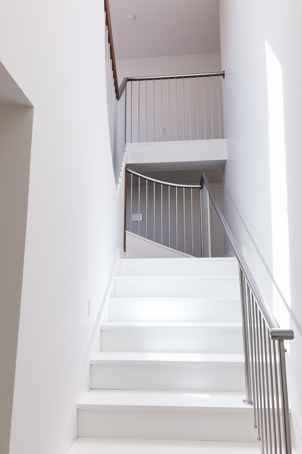 A sophisticated white staircase with an elegant railing. The staircase features clean lines and a sleek design, leading to an upper landing adorned with natural light. The railing is crafted from polished metal, providing a striking contrast against the white steps. Soft, neutral tones in the surrounding walls enhance the staircase's modern aesthetic.