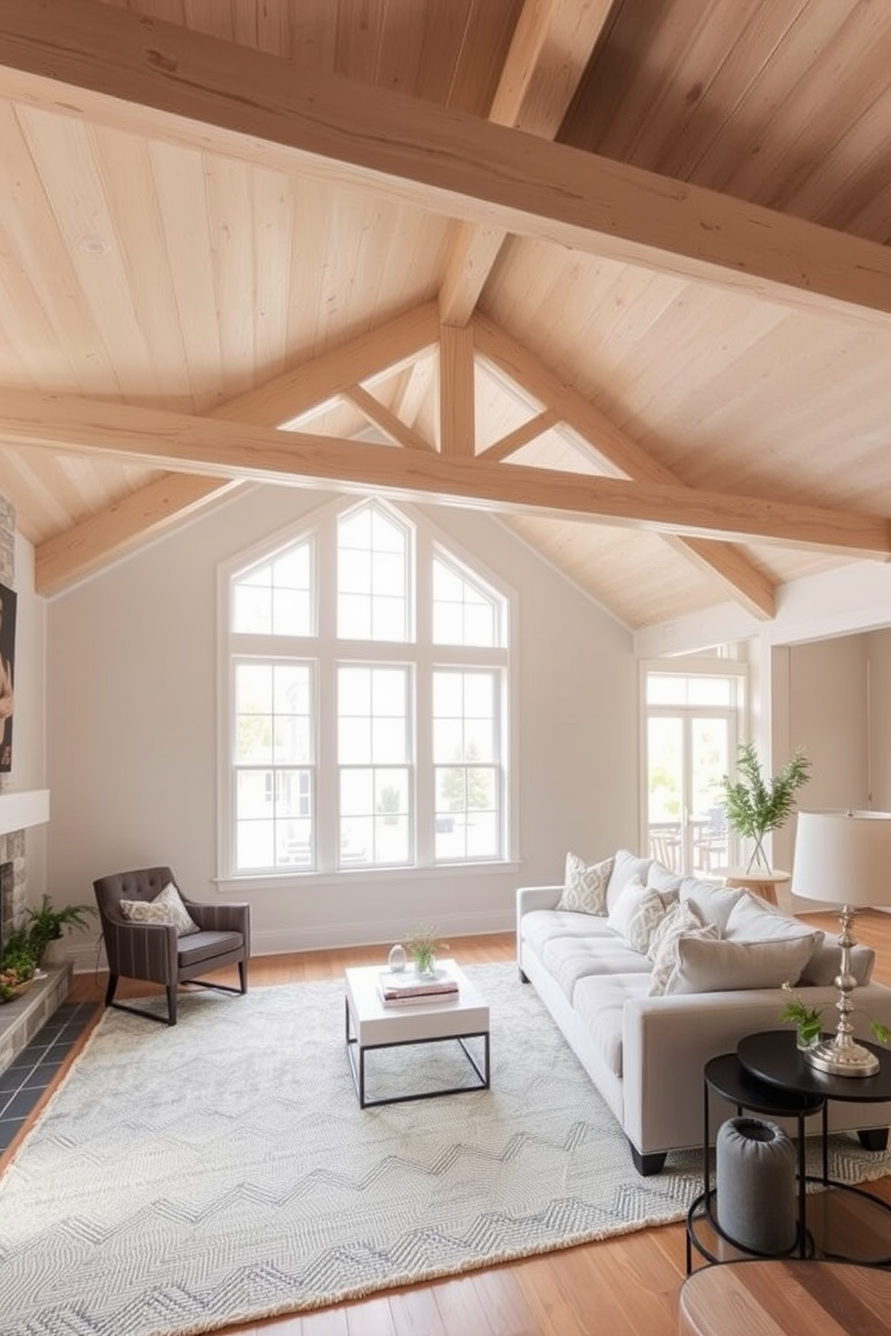 A light and airy living room featuring exposed light wood beams across the ceiling. The space is adorned with a large sectional sofa in soft neutral tones, complemented by a textured area rug and oversized windows that invite natural light.