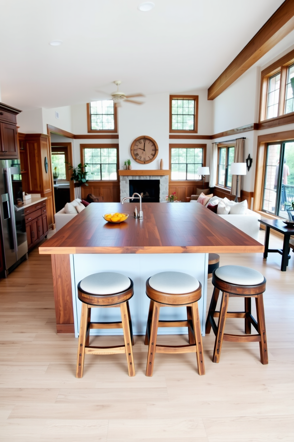 A warm and inviting kitchen features a large island with a polished wooden surface. Surrounding the island are three rustic wooden stools with comfortable cushions, creating a perfect spot for casual dining and socializing. The living room showcases a harmonious blend of comfort and style with plush sofas adorned in soft fabrics. Natural light floods the space through large windows, highlighting wooden accents and a cozy fireplace as the focal point of the room.