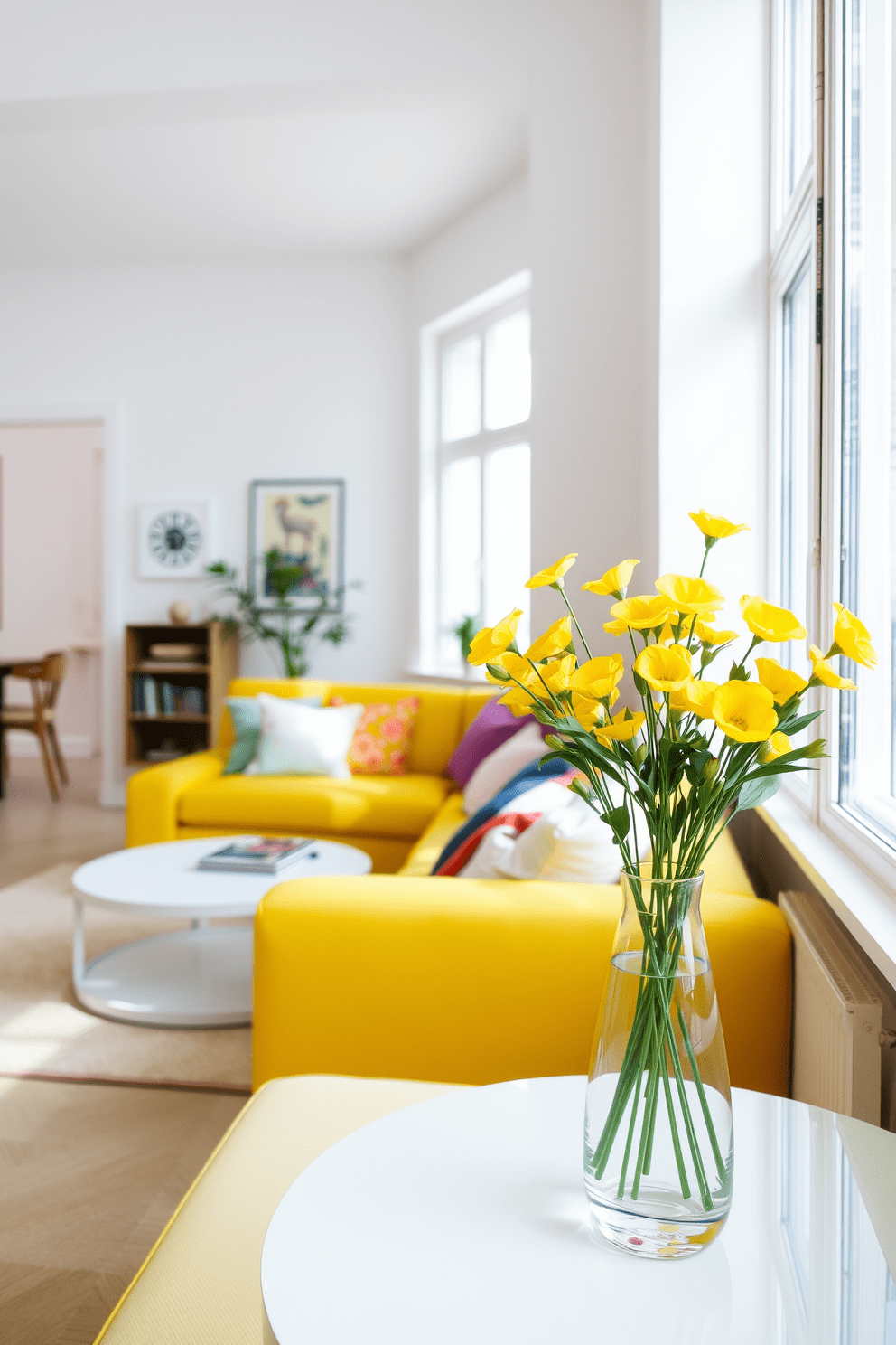 A bright and airy apartment filled with natural light. The living area features a cozy yellow sofa adorned with colorful cushions and a stylish coffee table. In one corner, a vibrant arrangement of yellow flowers sits in a sleek vase, adding a fresh touch to the space. The walls are painted in soft white, creating a perfect backdrop for the cheerful decor.