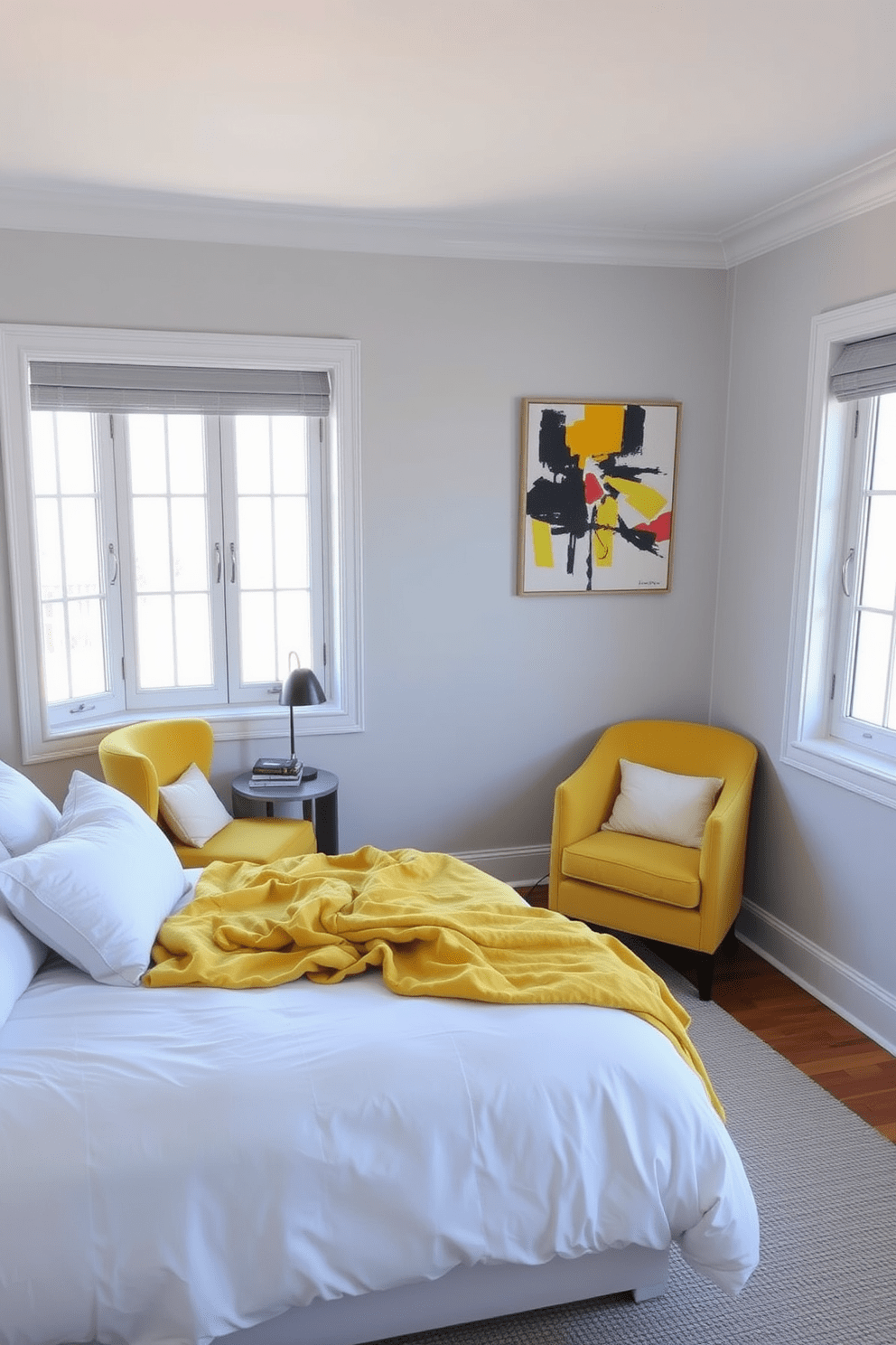 A cozy bedroom featuring a soft yellow throw blanket draped over a neatly made bed with white linens. The walls are painted in a light gray shade, and a small nightstand holds a stylish lamp and a stack of books. The room includes a cheerful yellow accent chair in the corner, complemented by a vibrant piece of abstract art above it. Natural light floods in through large windows, enhancing the warm and inviting atmosphere of the space.