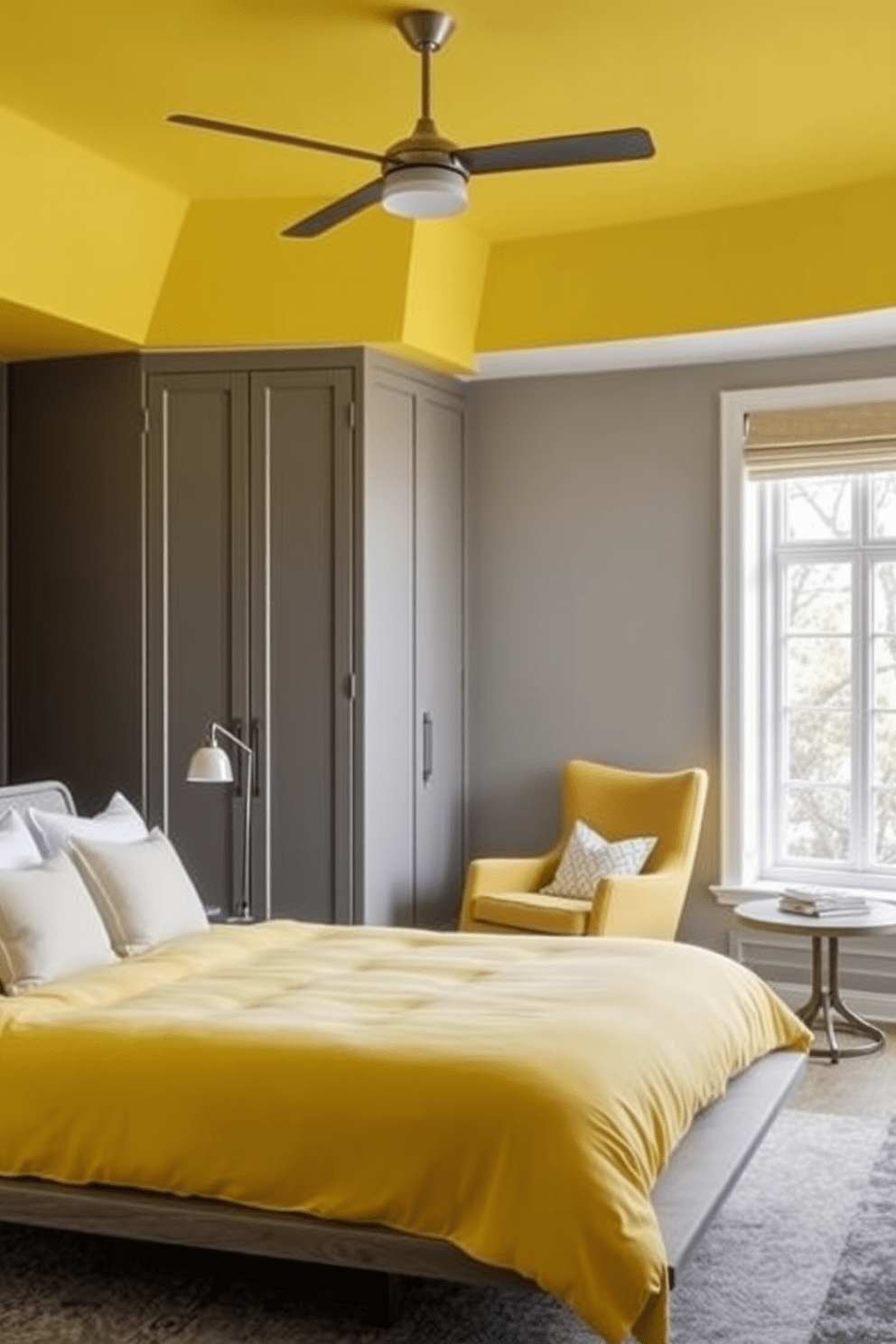 A vibrant yellow ceiling adds a surprising twist to the overall design of the bedroom. The walls are painted in a soft gray, creating a beautiful contrast with the cheerful ceiling. The room features a plush yellow bedspread on a modern platform bed, complemented by white and gray accent pillows. A cozy reading nook with a yellow armchair and a small side table is positioned by the window, inviting relaxation.