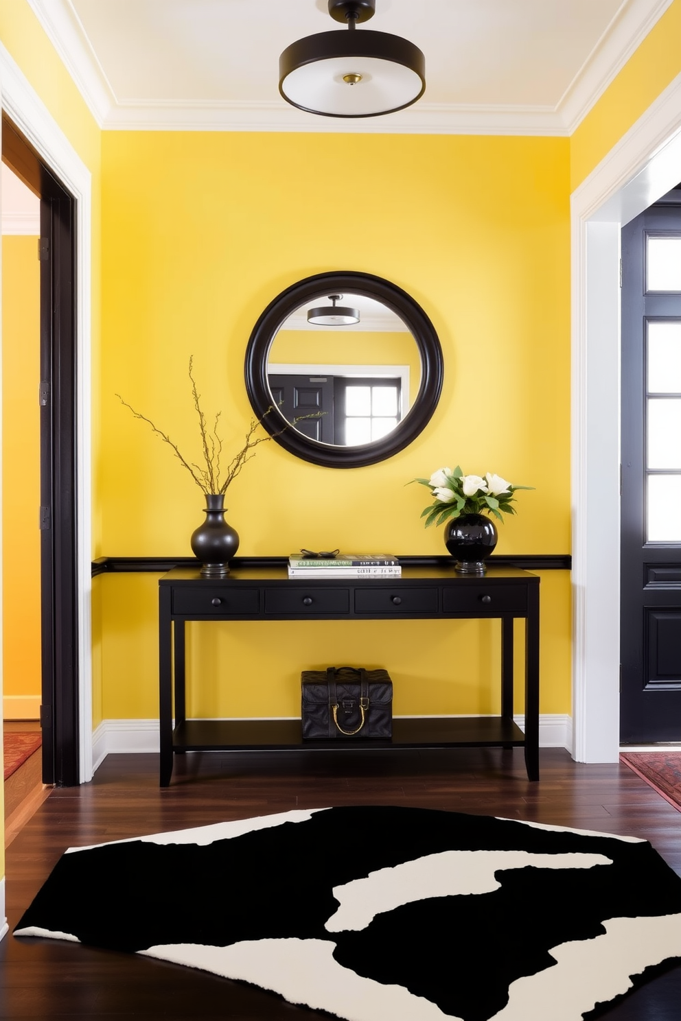 A bright foyer featuring a classic yellow and black color combination. The walls are painted a soft yellow, creating a warm and inviting atmosphere, while bold black accents are introduced through the trim and a statement console table. A large round mirror with a black frame hangs above the console, reflecting light and enhancing the space. A patterned black and white rug lies underfoot, adding texture and contrast to the overall design.