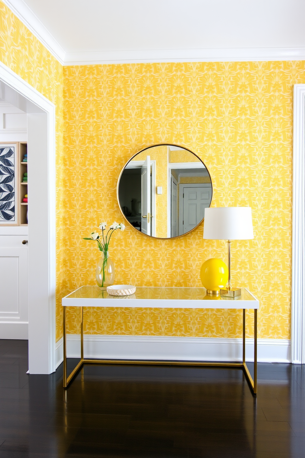 A bright foyer adorned with bold yellow wallpaper featuring geometric patterns creates an inviting atmosphere. The space is complemented by a sleek console table with a glass top and gold accents, alongside a large round mirror reflecting the vibrant design.