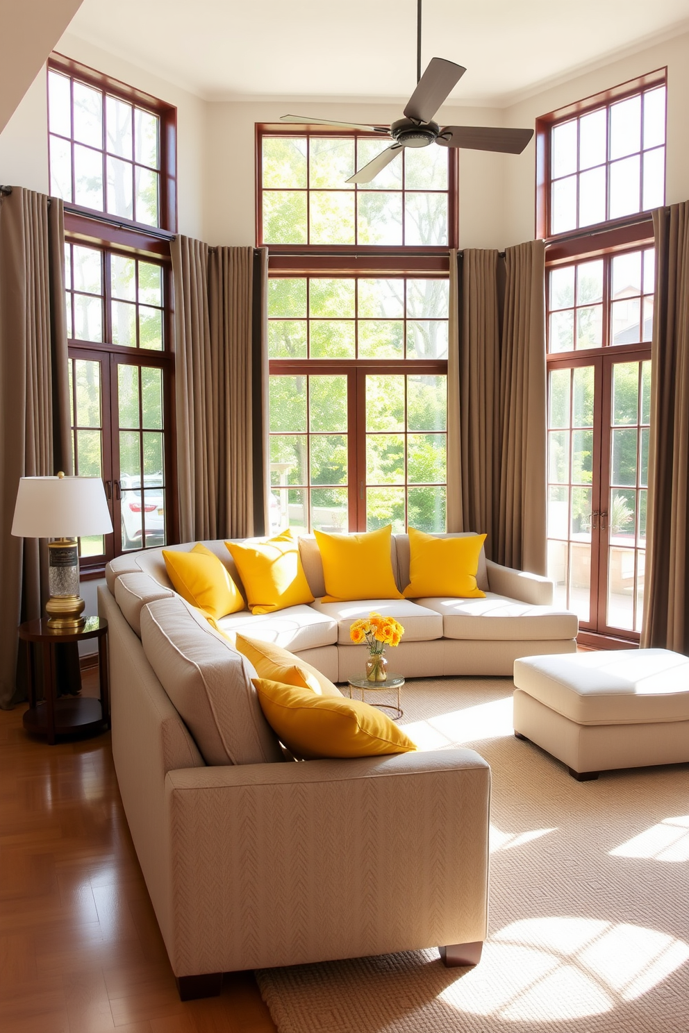 A bright and inviting living room featuring a neutral sofa adorned with vibrant yellow cushions. The space is enhanced by large windows allowing natural light to flood in, creating a warm and cheerful atmosphere.