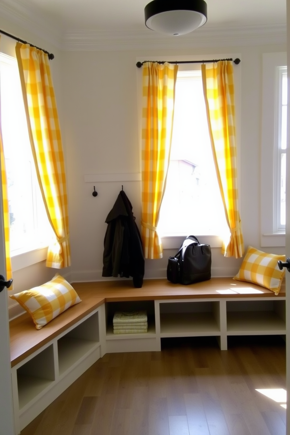 A bright and inviting mudroom features yellow and white striped curtains that softly frame the windows, allowing natural light to filter in. The space includes built-in benches with storage underneath and hooks for hanging coats, creating a functional yet stylish entryway.