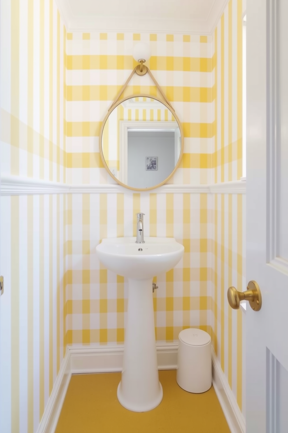 A playful powder room featuring yellow and white striped wallpaper that adds a cheerful touch to the space. The room includes a sleek white pedestal sink and a round mirror with a gold frame, enhancing the bright and inviting atmosphere.