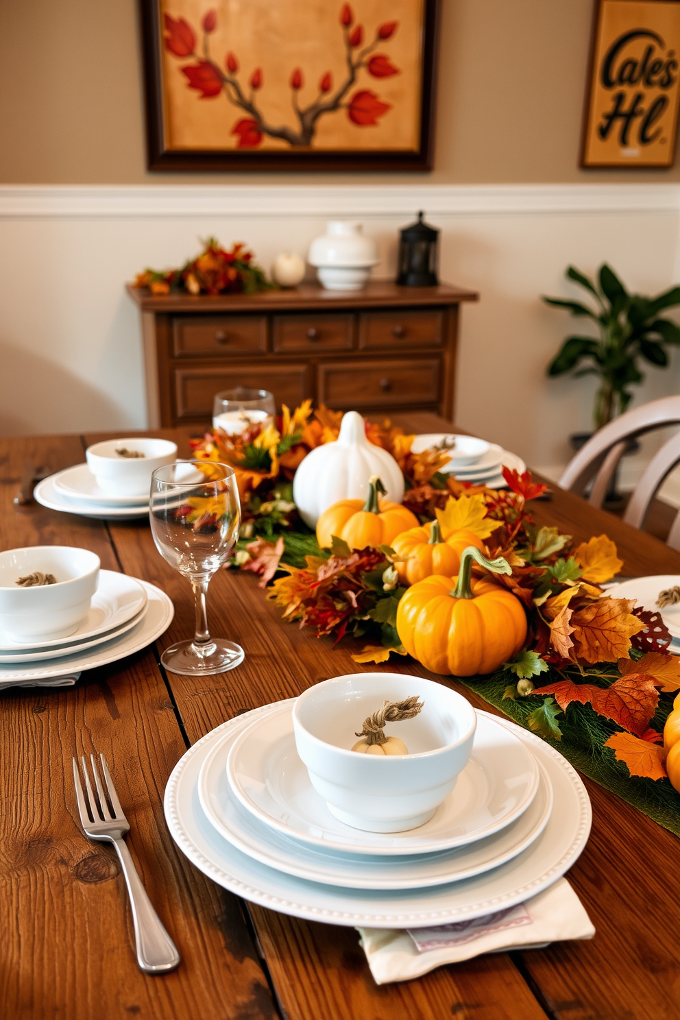 Crisp white dishes are elegantly arranged on a rustic wooden dining table, complemented by vibrant autumn accents such as small pumpkins and colorful leaves. The backdrop features warm-toned wall art and soft lighting that creates a cozy ambiance for fall gatherings.