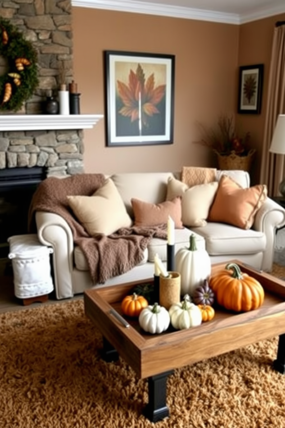 A cozy fall-themed living room filled with warm hues and rustic elements. A large, inviting sofa covered in soft, textured throws is positioned in front of a stone fireplace. On the coffee table, a rustic wooden tray holds an assortment of decorative pumpkins and candles. The walls are adorned with framed autumn-themed art, and a plush area rug in earthy tones anchors the space.