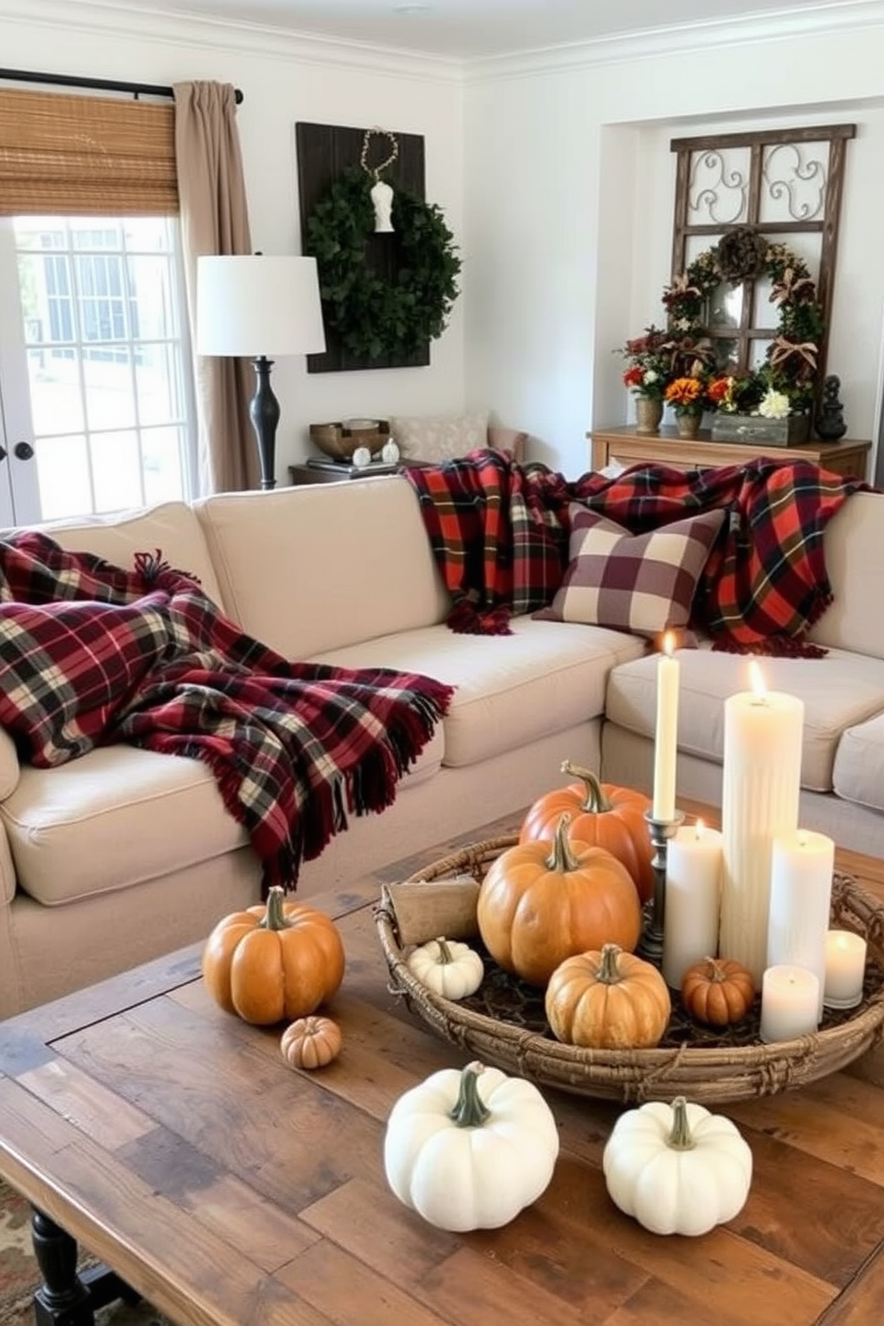 A cozy living room adorned with warm plaid throws draped over a plush sofa. The space features autumn-inspired decor, including pumpkins and candles arranged on a rustic coffee table.