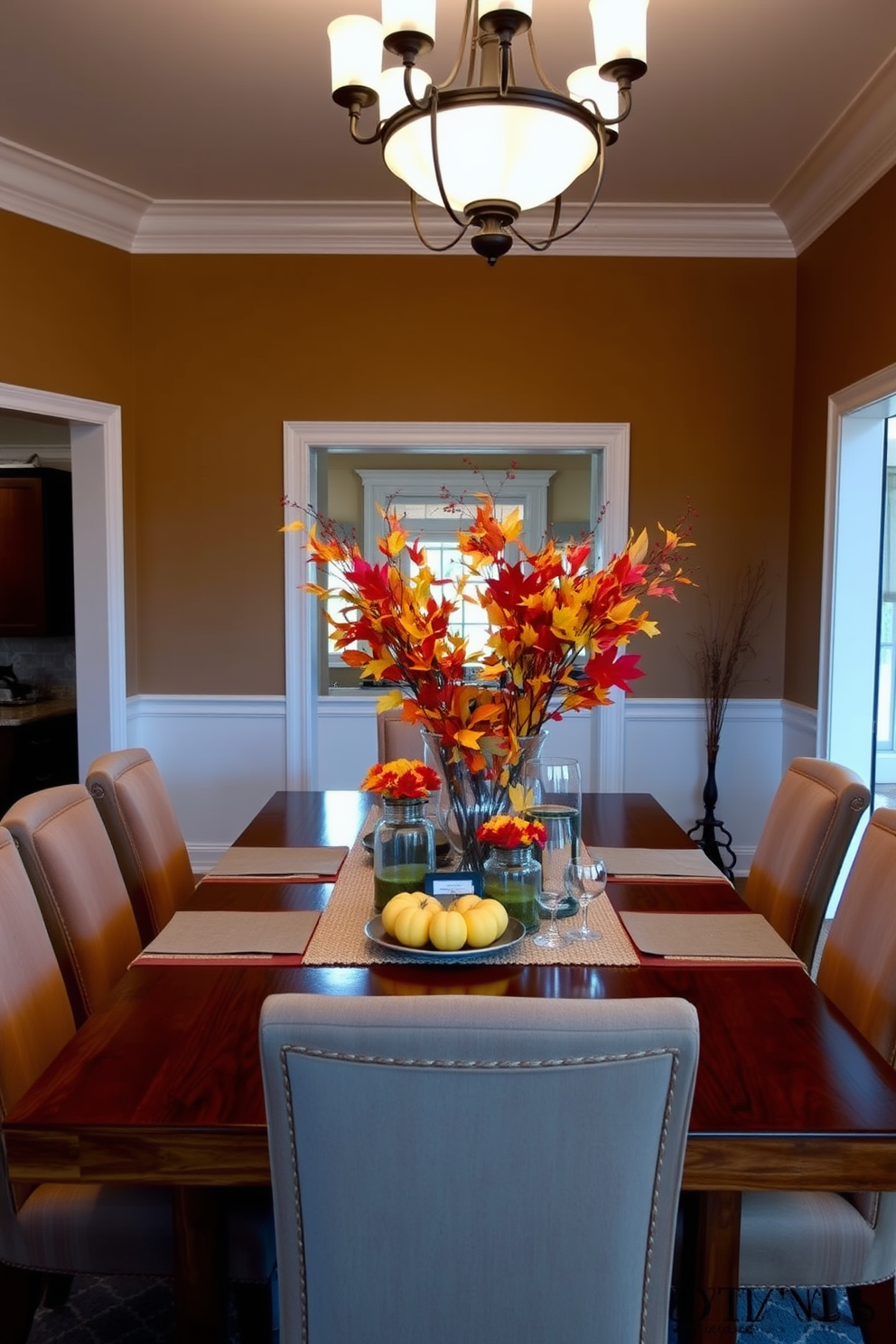 Create an elegant fall dining room setting featuring a large wooden dining table surrounded by upholstered chairs. On the table, place several glass vases filled with vibrant autumn foliage in shades of orange, red, and yellow. The walls should be painted in a warm neutral tone, enhancing the cozy atmosphere of the room. Soft lighting from a stylish chandelier above creates a welcoming ambiance for family gatherings.