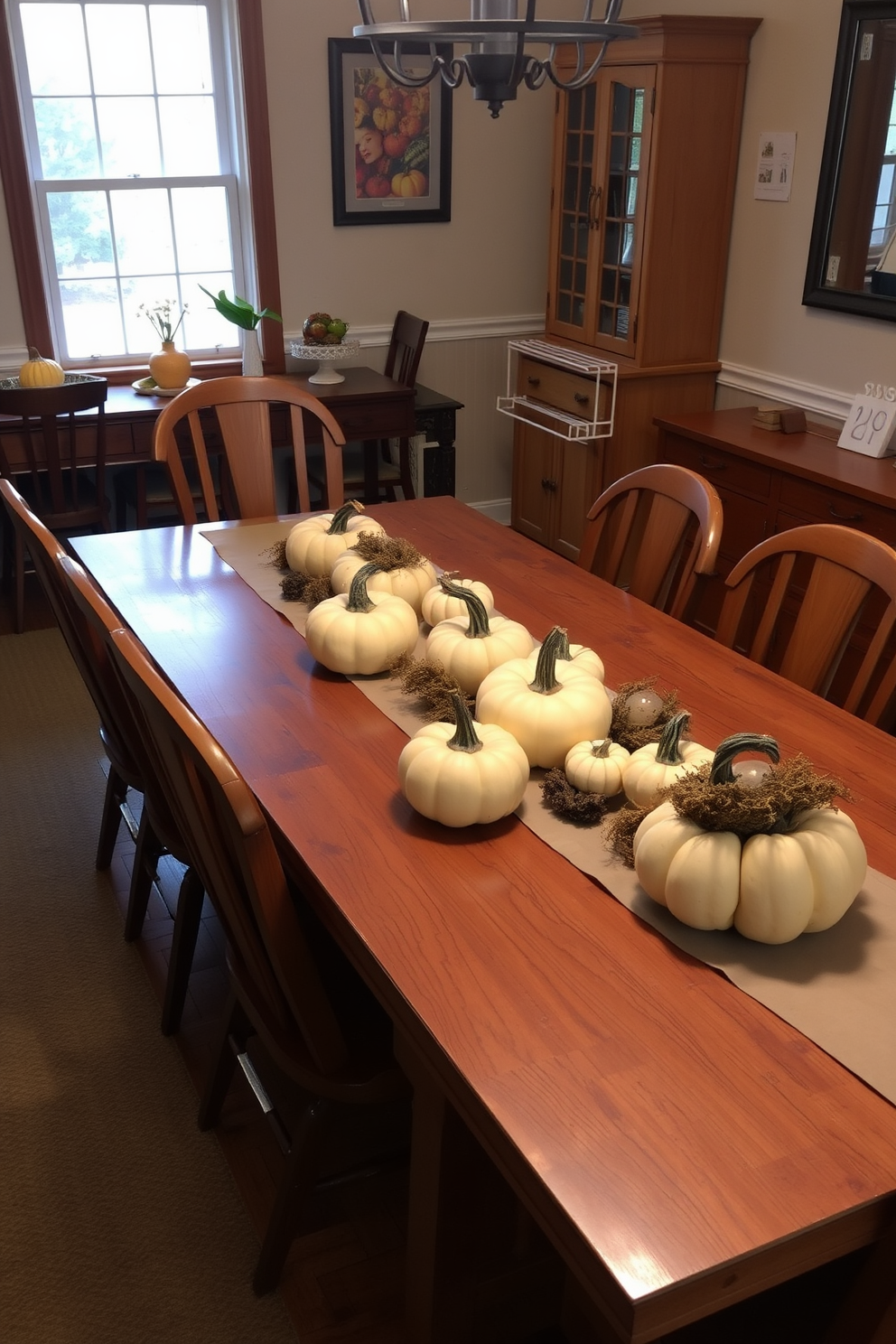 A warm and inviting dining room features a large wooden table adorned with rustic centerpieces made of various sizes of pumpkins. The table is surrounded by mismatched wooden chairs, and soft, ambient lighting creates a cozy atmosphere for family gatherings.