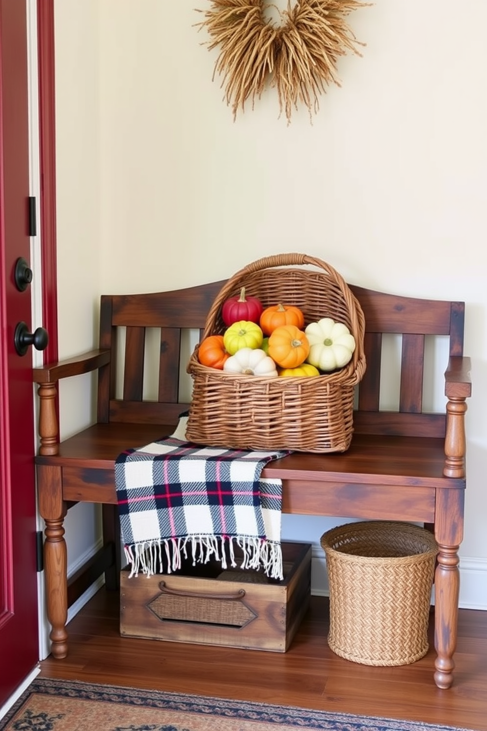 A warm and inviting fall entryway features a rustic wooden bench adorned with colorful gourds arranged in a woven basket. The walls are painted in a soft cream hue, and a cozy plaid throw blanket drapes over the bench, enhancing the seasonal charm.