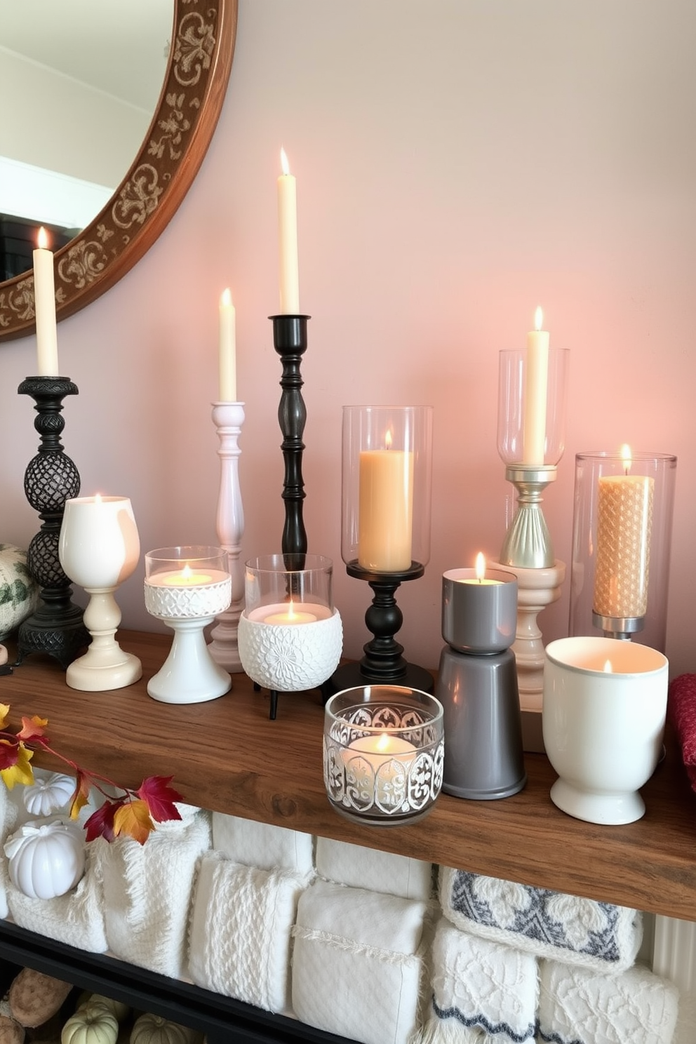 A collection of unique candle holders made from various materials such as ceramic glass and metal is displayed on a rustic wooden mantel. Each candle holder features intricate designs and varying heights creating a visually appealing arrangement. The fireplace is adorned with autumn-themed decorations including small pumpkins colorful leaves and cozy blankets. Warm-toned candles are lit within the holders casting a soft glow that enhances the inviting atmosphere of the fall season.