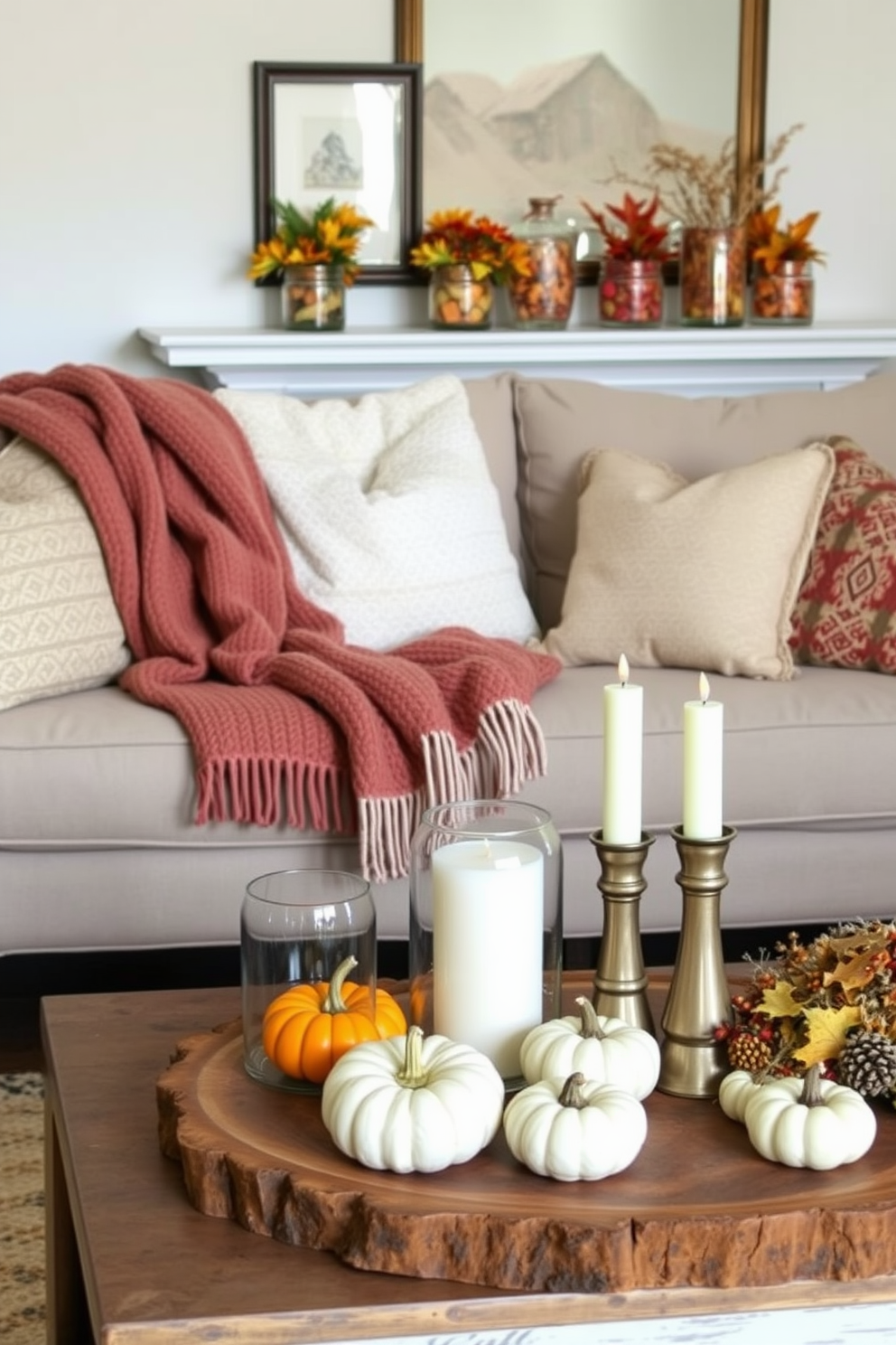 A cozy fall living room adorned with glass jars filled with seasonal treats such as colorful leaves and mini pumpkins. The seating area features a plush, oversized sofa draped with a warm knitted throw, and a rustic coffee table displaying a curated arrangement of candles and autumn accents.