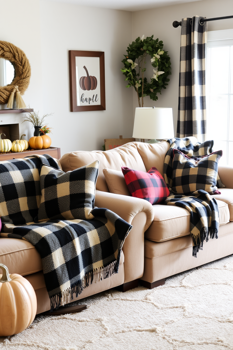 A cozy living room adorned with warm plaid throw blankets draped over plush sofas. The space is accented with autumnal decor, featuring pumpkins and rustic elements that evoke a welcoming fall atmosphere.