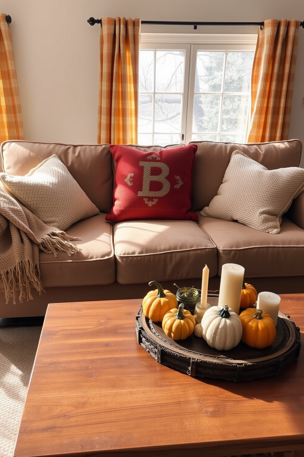 Textured pillows in warm hues are arranged on a cozy, oversized sofa in a sunlit living room. The sofa is complemented by a woven throw blanket draped casually over one arm, and a rustic wooden coffee table sits in front, adorned with seasonal decor. Surrounding the sofa, autumn-inspired decorations create a welcoming atmosphere. A collection of small pumpkins and candles in varying heights are artfully placed on the table, while a backdrop of soft, golden-hued curtains gently frames the window.