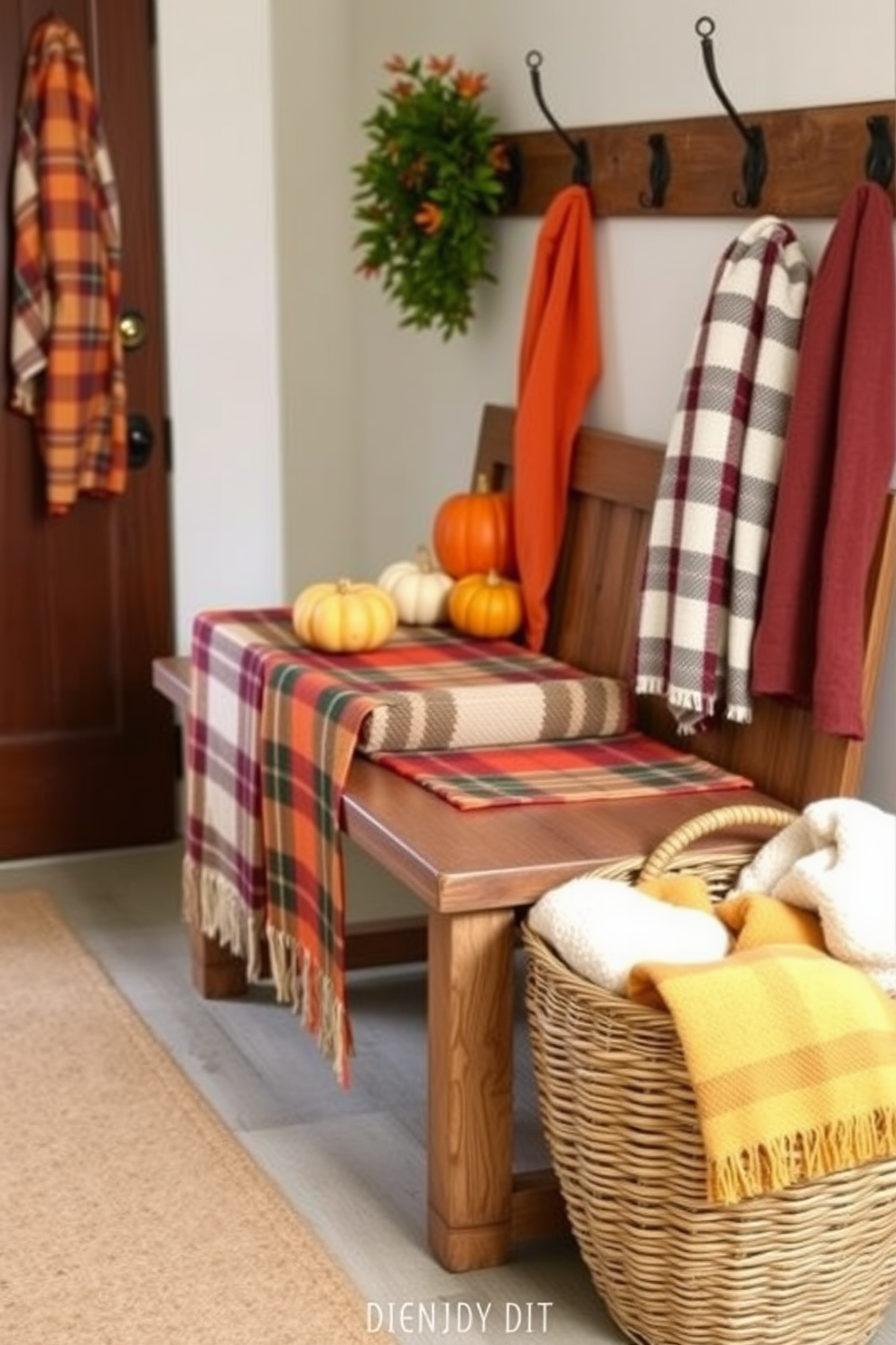 A cozy mudroom adorned with plaid table runners in warm autumn hues. The runners are draped over a rustic wooden bench, complemented by decorative pumpkins and a woven basket filled with cozy blankets.