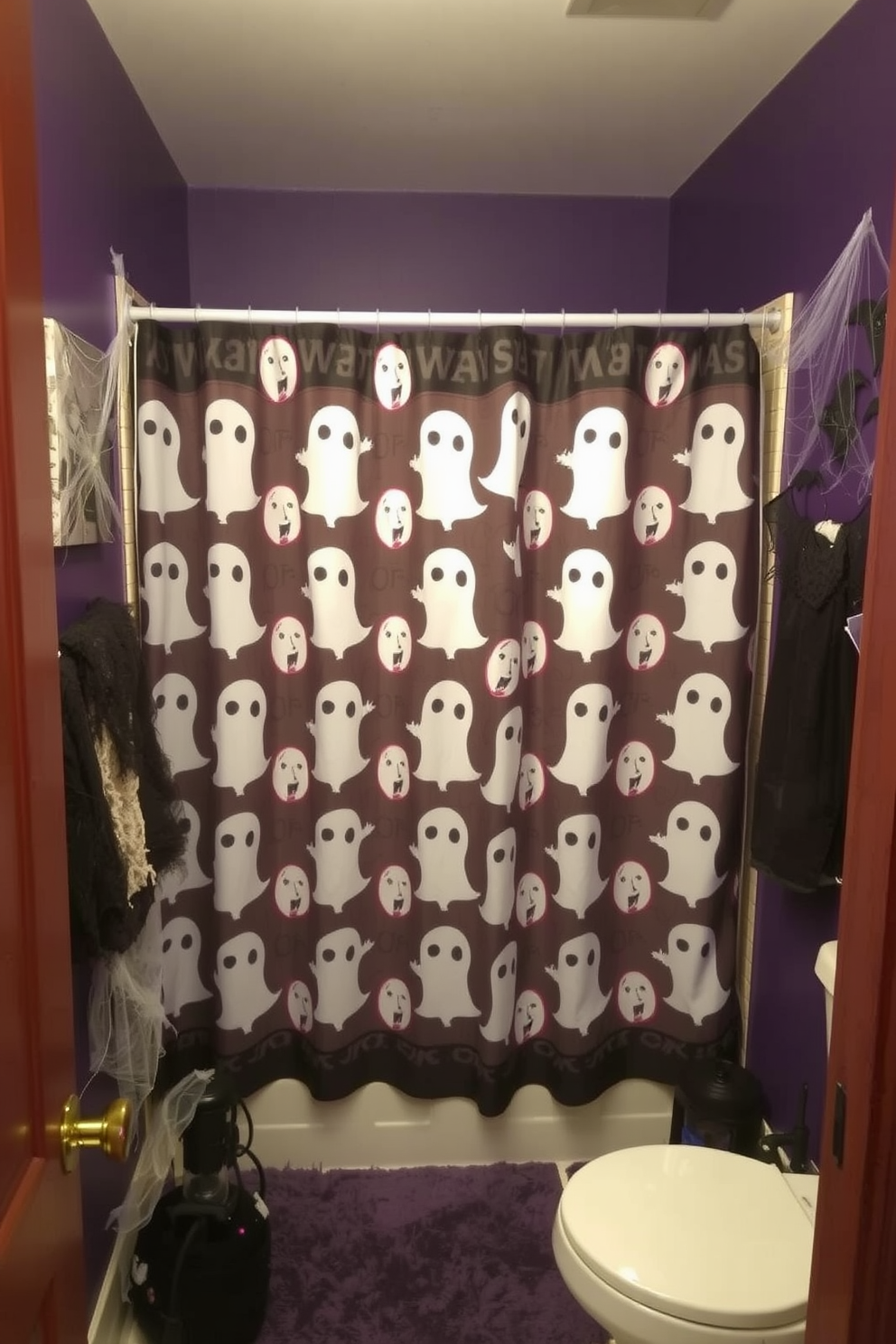 A Halloween-themed bathroom featuring a spooky shower curtain adorned with ghost prints. The walls are painted in a deep purple hue, and a collection of eerie decorations, such as cobwebs and bats, are strategically placed around the room.