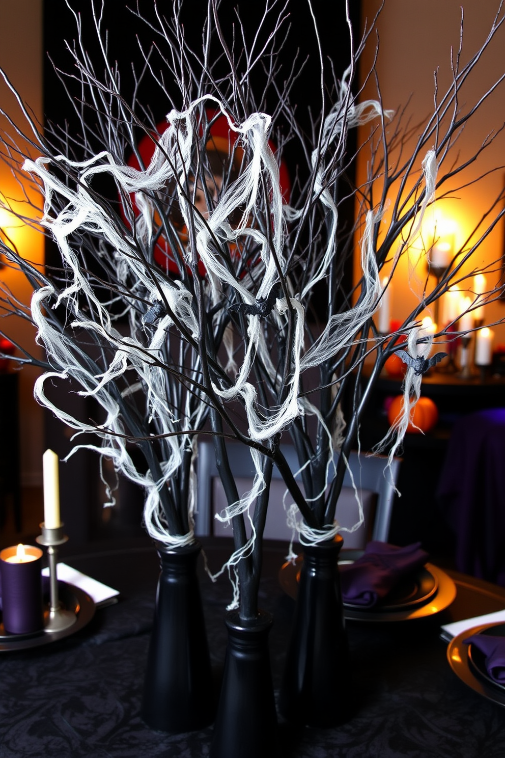 Spooky tree branches arranged in tall black vases create an eerie yet elegant centerpiece for your Halloween decor. The branches are adorned with artificial cobwebs and small hanging bats to enhance the spooky atmosphere. In the background, a dimly lit setting with flickering candles adds to the haunting ambiance. Accents of deep purple and orange in the surrounding decor complete the Halloween theme.