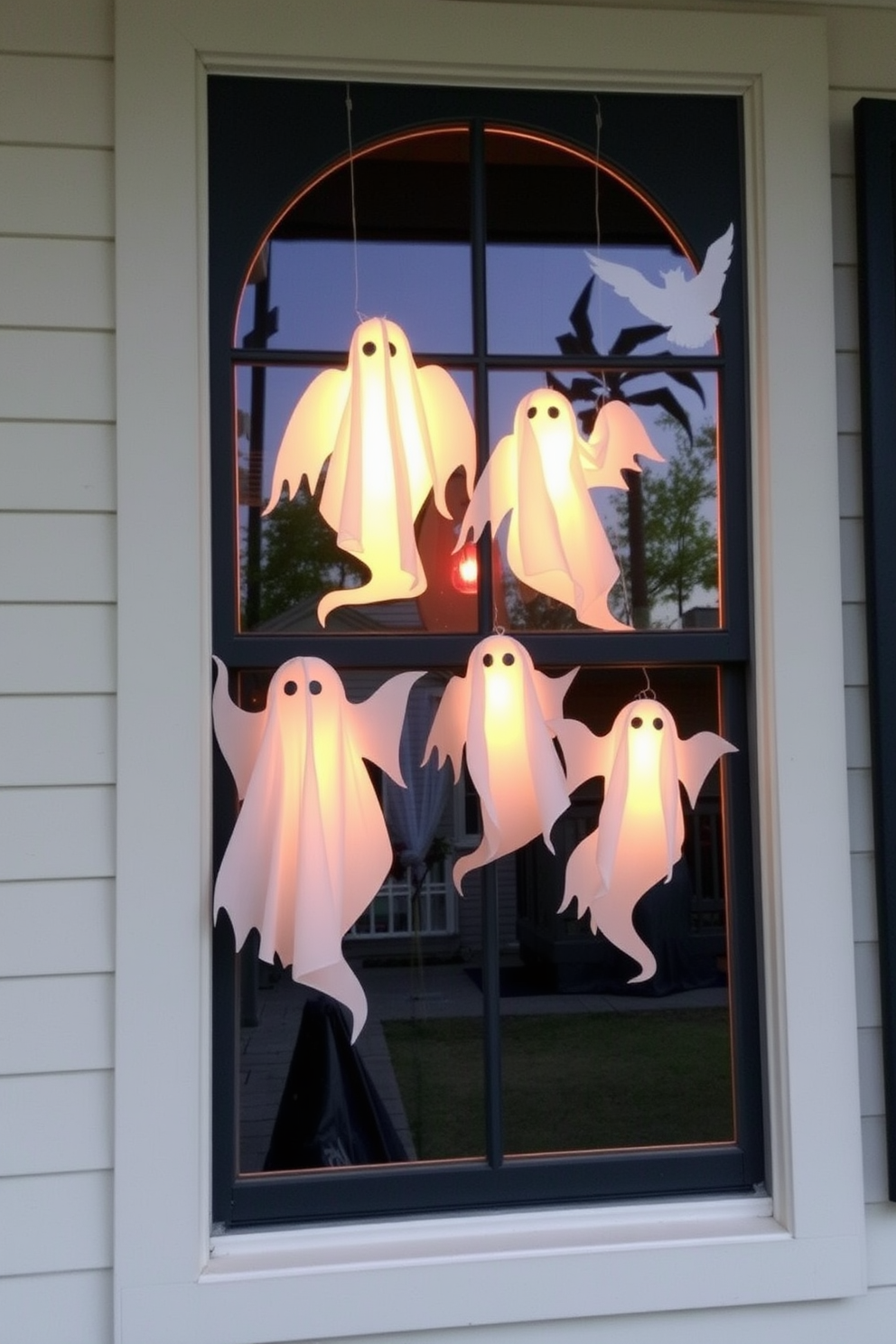 Create an enchanting Halloween atmosphere by placing ghostly silhouettes on window panes. Use sheer white fabric to cut out various ghost shapes that gently sway with the breeze, adding a spooky yet whimsical touch to your decor.