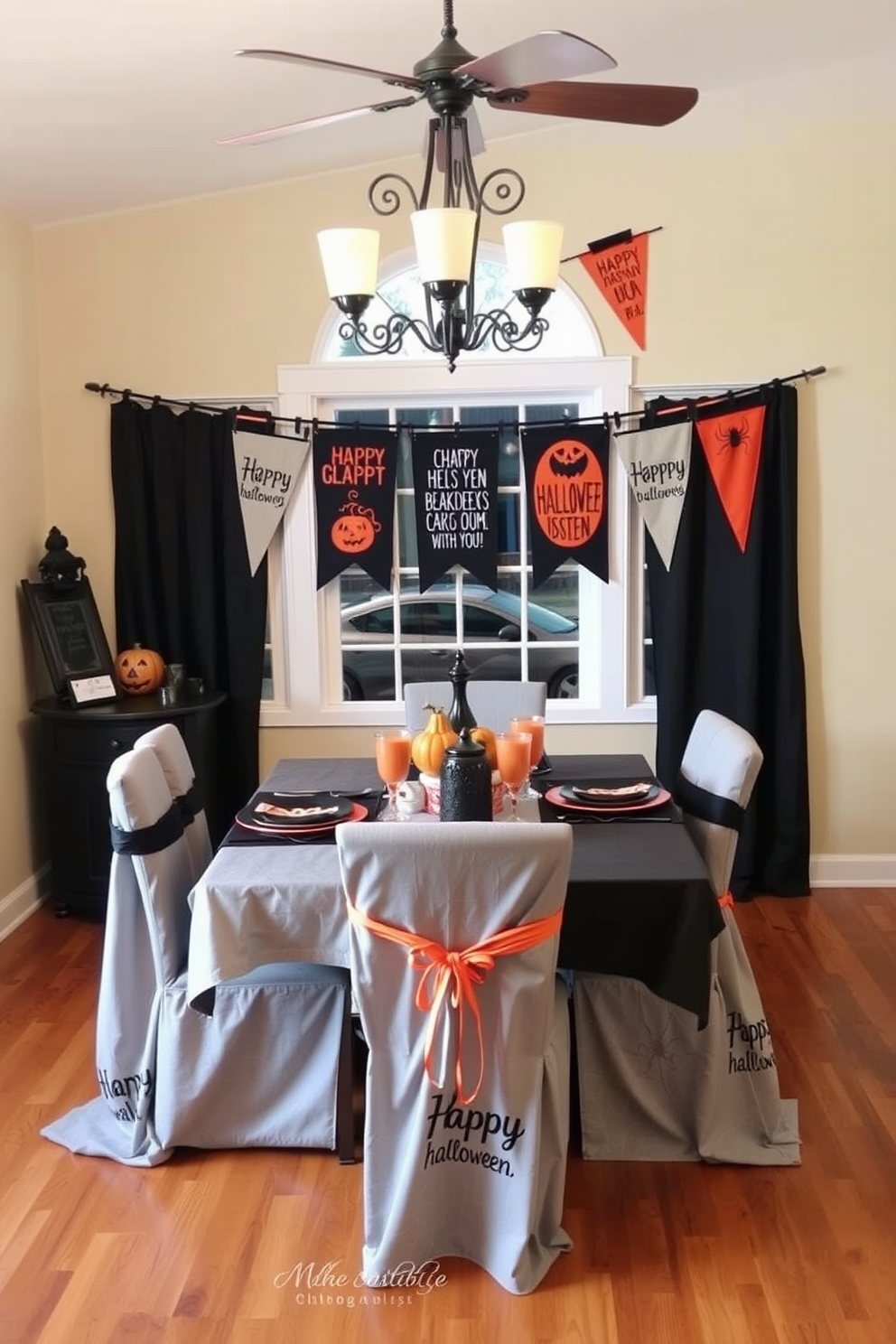 A cozy dining room adorned with festive banners featuring playful Halloween sayings. The table is set with black and orange tableware, surrounded by chairs draped in spiderweb-patterned fabric.