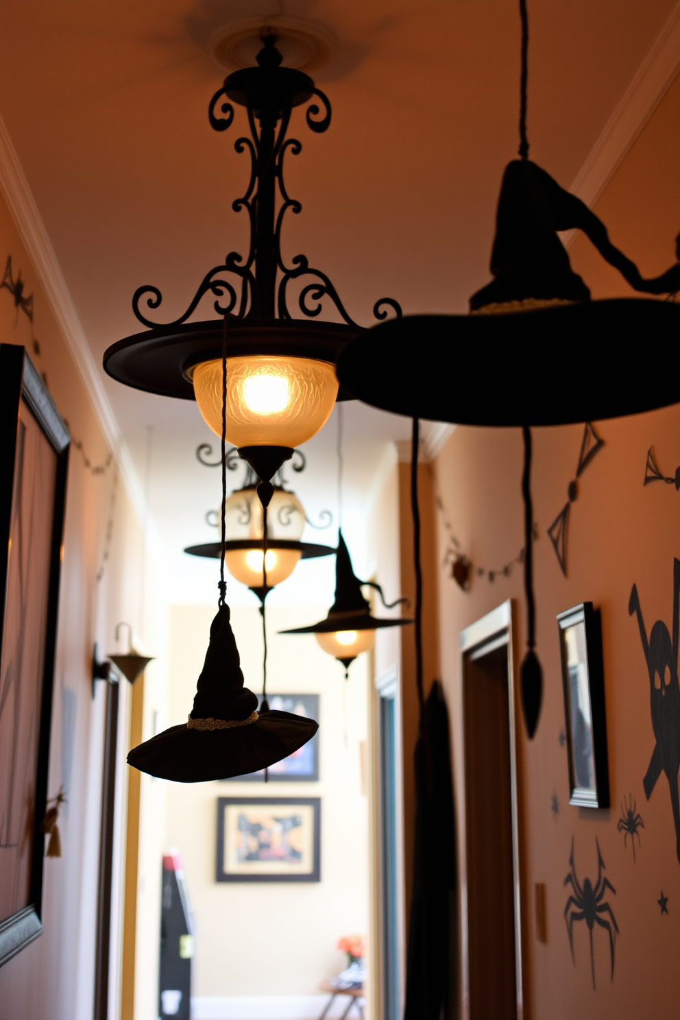 Hanging witch hats dangle from elegant light fixtures casting playful shadows in a festive hallway. The walls are adorned with spooky artwork and cobwebs, creating an enchanting atmosphere for Halloween celebrations.