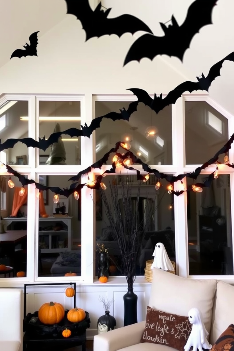 A cozy loft adorned for Halloween features bat garlands strung elegantly across the windows. The decor includes whimsical touches like miniature pumpkins and ghostly accents that enhance the festive atmosphere.