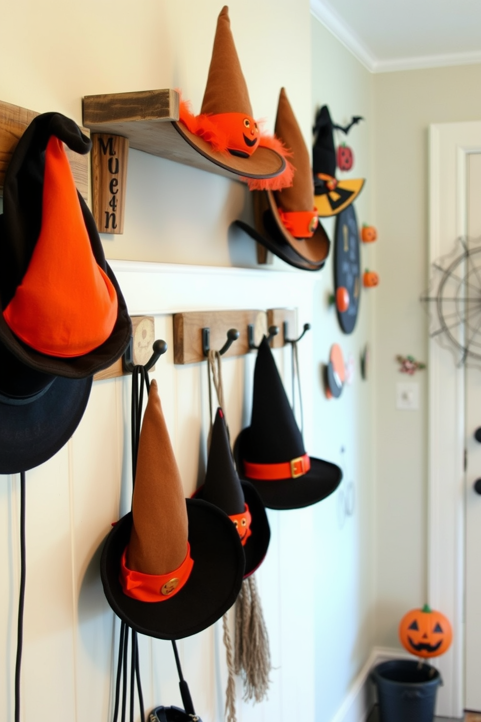 Witch hats of various sizes are hanging on rustic wooden hooks in a cozy mudroom. The walls are adorned with playful Halloween-themed decor, creating a festive and inviting atmosphere.