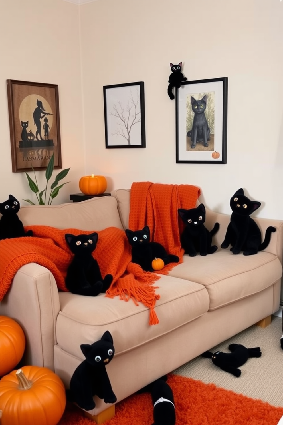 A cozy small living room decorated for Halloween features black cat plushies playfully scattered throughout the space. The walls are adorned with subtle autumn-themed artwork, and a warm orange throw blanket is draped over a plush sofa.