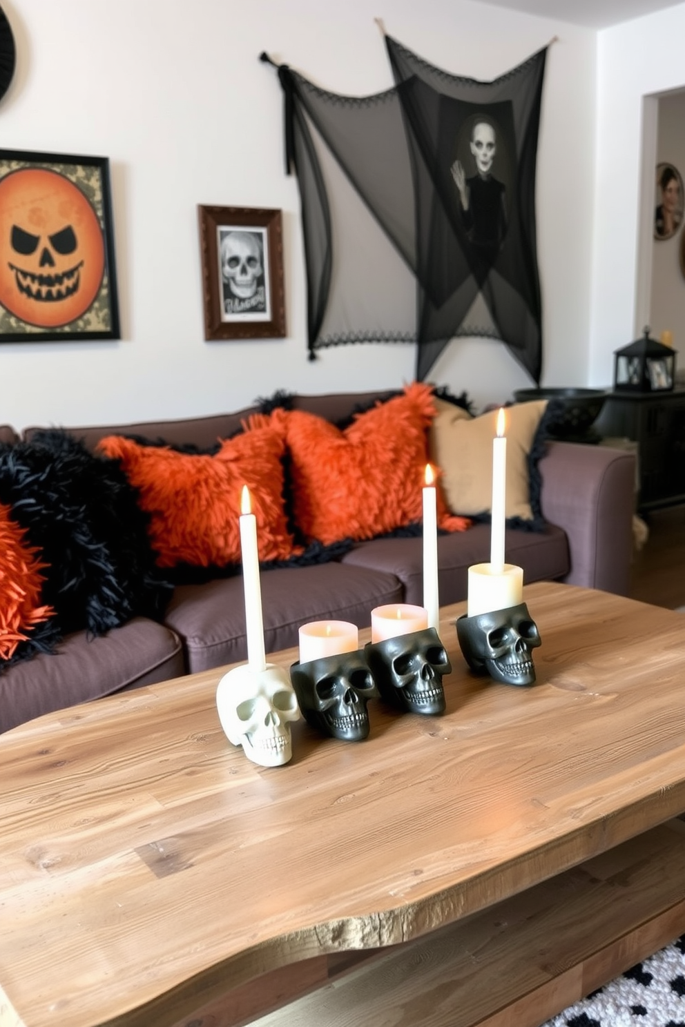 A cozy small living room decorated for Halloween features candles in skull-shaped holders placed on a rustic wooden coffee table. The walls are adorned with spooky artwork, and plush black and orange throw pillows add a festive touch to the seating area.