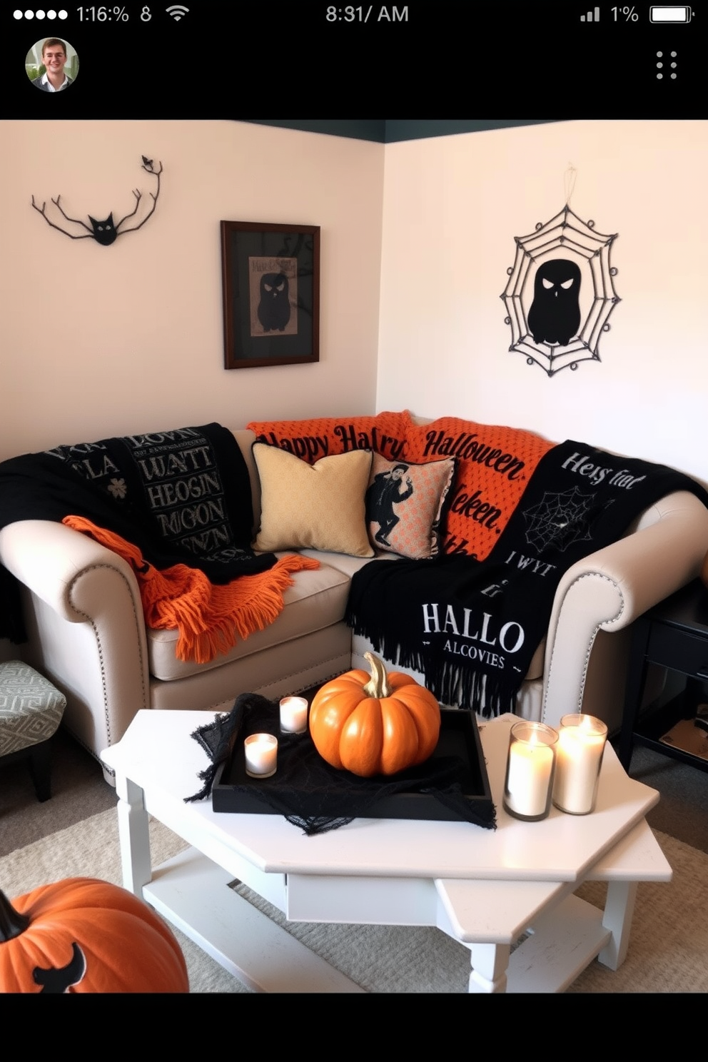 A cozy living room corner decorated for Halloween. The space features a small sofa adorned with black and orange throw blankets, creating a festive yet inviting atmosphere. A decorative pumpkin sits on the coffee table, surrounded by flickering candles. The walls are adorned with subtle Halloween-themed artwork, enhancing the seasonal charm without overwhelming the small space.