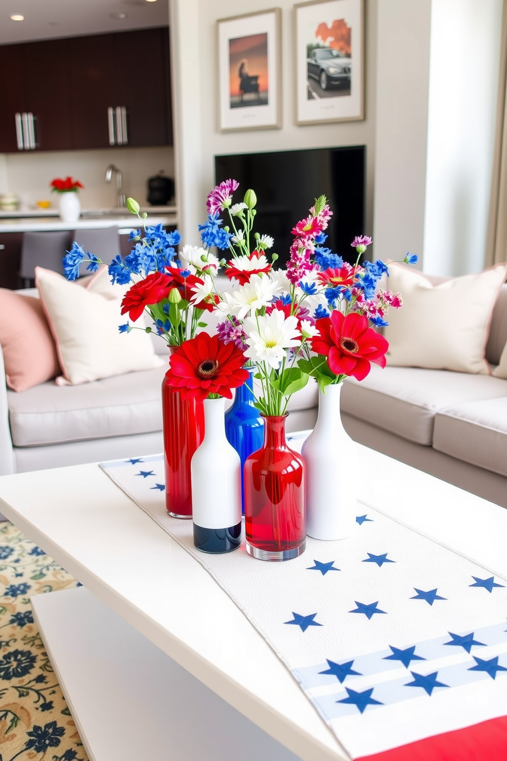 A vibrant arrangement of red white and blue vases sits on a sleek coffee table in a modern apartment living room. The vases vary in height and shape, filled with fresh flowers that celebrate the spirit of Independence Day. The table is adorned with a festive table runner featuring stars and stripes, complementing the patriotic theme. Soft, neutral-toned cushions on the sofa provide a cozy contrast to the bold colors of the vase arrangement.