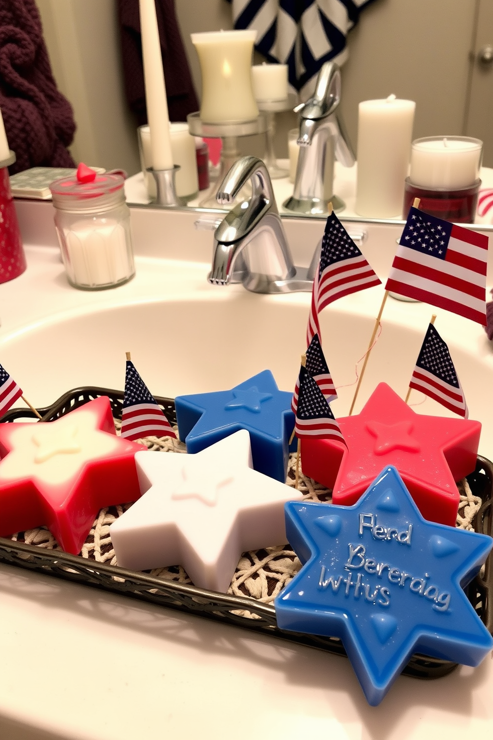 Star shaped soap bars in red white and blue colors are arranged on a decorative tray in the bathroom. The soap bars are complemented by small American flags and festive candles to enhance the Independence Day theme.