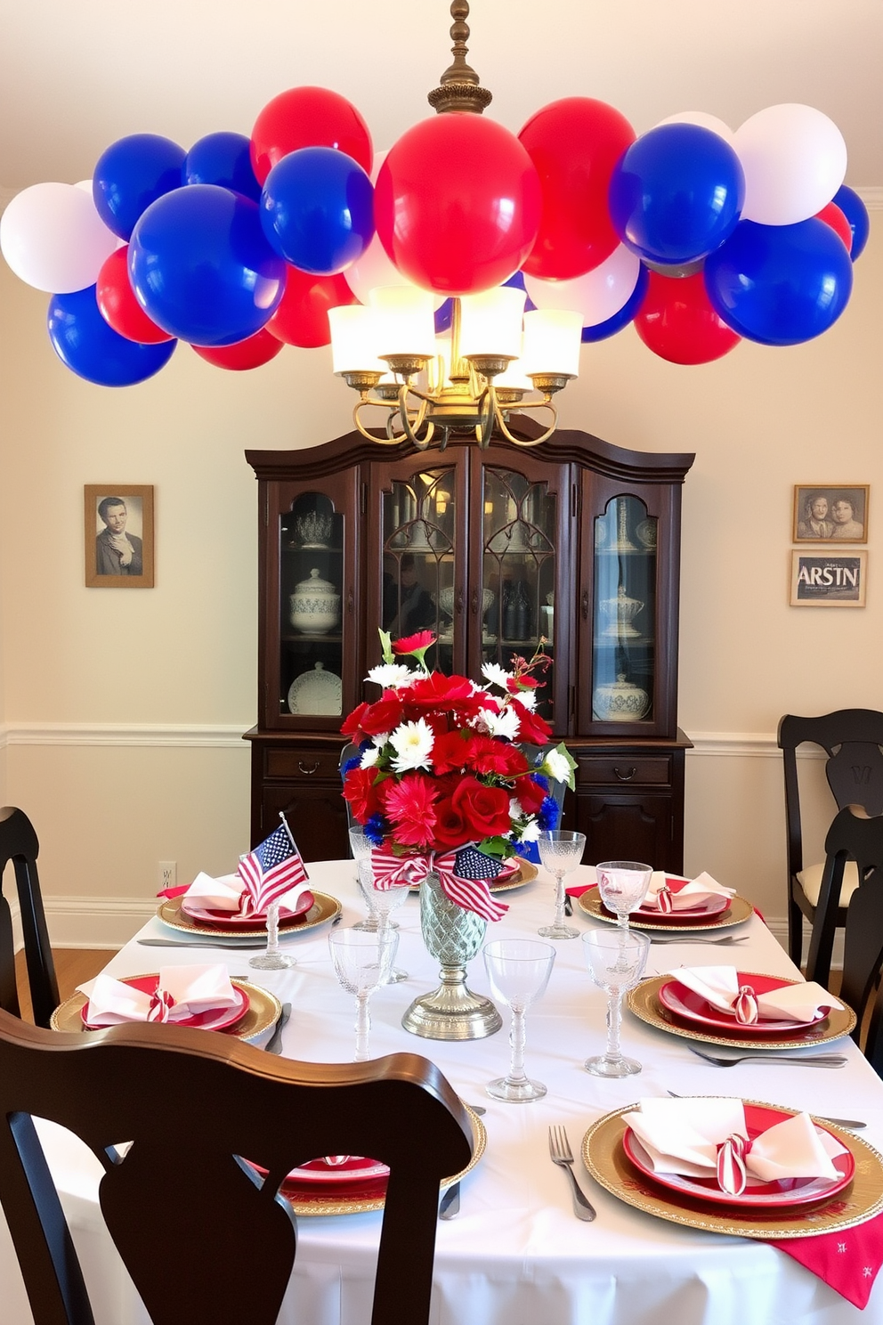 A festive dining room setting adorned with a red blue and white balloon garland overhead. The table is elegantly set with star-spangled tableware and a centerpiece featuring fresh flowers in patriotic colors.