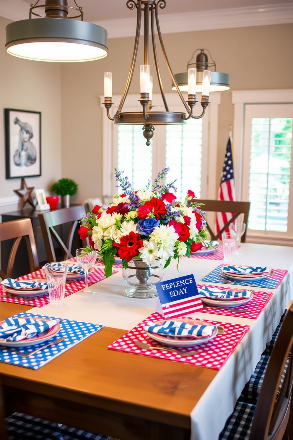 A festive dining room setting celebrating Independence Day. The table is adorned with red white and blue patterned placemats that evoke a sense of patriotism. Above the table, a striking centerpiece features a mix of fresh flowers in red white and blue hues. Soft lighting from elegant pendant fixtures creates a warm and inviting atmosphere for guests.