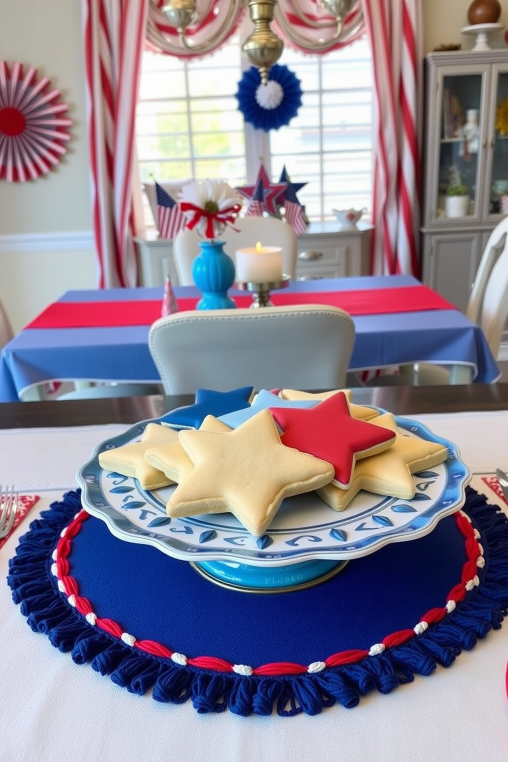 Star shaped cookies arranged on a decorative platter serve as festive table decor for an Independence Day celebration. The dining room features a patriotic color scheme with red white and blue accents including table linens and centerpieces.